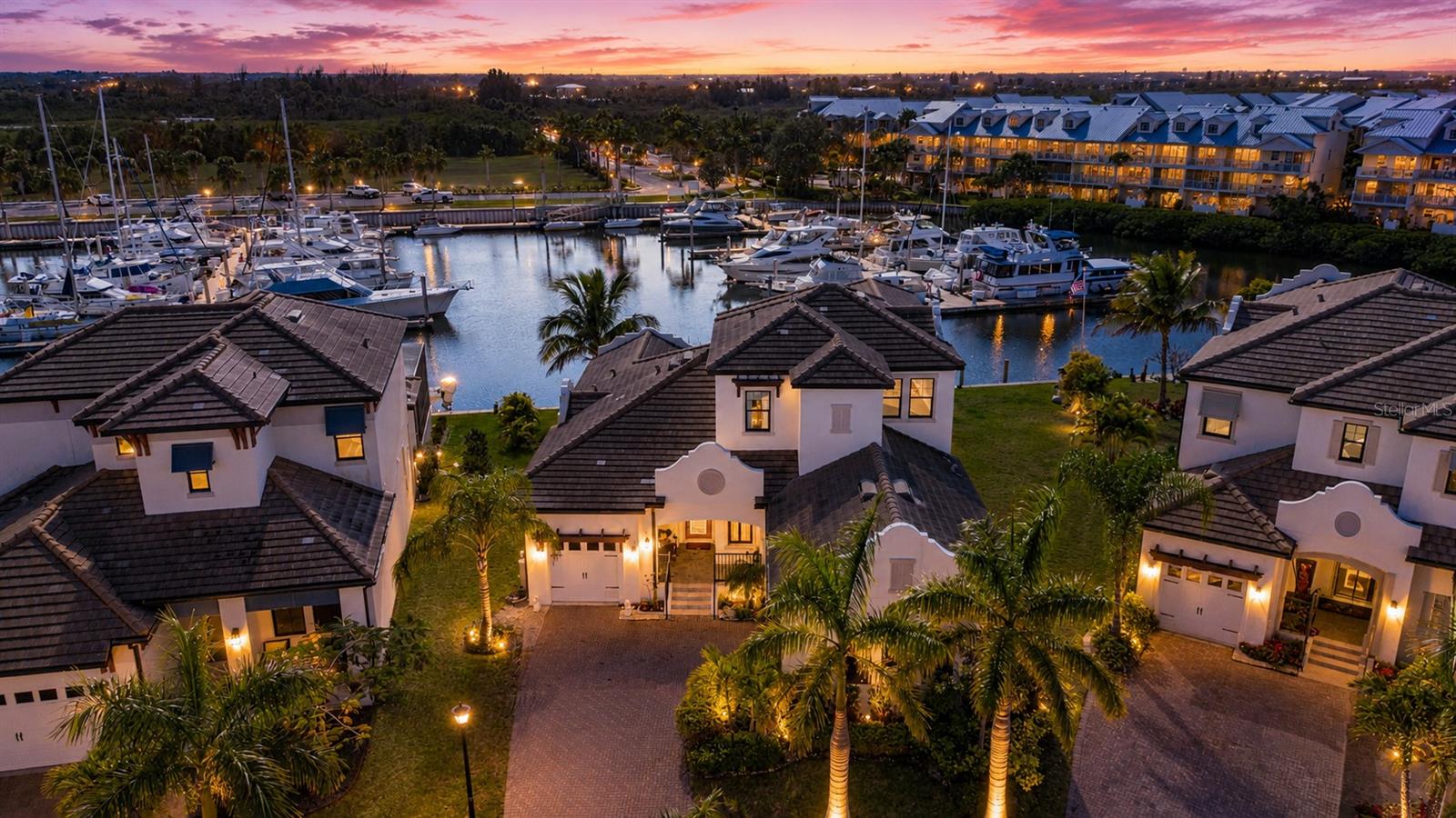 Significant Price Reduction - under $1.0 million for this exceptional home with one of the largest waterfront lots in this resort style community!  Rare opportunity to own a luxury WATERFRONT retreat with private dock at an exceptional new price. This home combines elegance, comfort, and direct water access to Tampa Bay - offering unbelievable value for the discerning buyers. This exquisite WATERFRONT home features a composite boat dock w/ lift, additional 32’ floating aluminum dock, and one of the few largest premium lots w/ an expansive 133 feet of shore line. The deep, sailboat water located within the resort community of Little Harbor is a boater’s dream with quick access to the Bay & Gulf with no lifts or bridges. Upon entering the home the first thing that greets you is the expansive, breathtaking water views from the Great Room. The home’s versatile open floor plan featuring sand colored, wood flooring is perfect for entertaining a large gathering of family and friends as well as more intimate settings. The spacious kitchen is a chef's delight with a gas cook top, quartz countertops, extensive storage cabinets w/ under mount lighting, pantry, and an oversized center island with plenty of inviting seating available. From the living area, the large, private lanai with outdoor kitchen and seating beckons. Enjoy the soothing water views each morning, afternoon, and evening with a beverage of your choice as the variety of birds as well as the dolphin and manatee entertain. The first floor also features the primary bedroom w/ an electric fireplace and ensuite bathroom, a half bath, laundry room, dining area and a flex space that can also be used as a formal dining room. As you take the stairs or choose the convenient 3-stop ELEVATOR to the second level, the additional bedrooms do not disappoint. This floor not only offers additional size in the form of a large loft, but a desirable spacious, covered terrace for enhanced, sweeping views of the waterfront and sunset skies. This premium, oversized waterfront lot is large enough for a significant sized pool - why buy a home with the previous seller's pool choice in mind when you can custom design your own - a swim up bar with submerged bar stools, in-water loungers, fountains, hot tub, etc!  The Seller hired a certified engineer to draw plans, which were submitted and approved by the Architectural Review Board and can be shared with the home’s new owner.  For the car enthusiast, with 12’ ceilings the split 3-car garage can easily accommodate twice as many cars with the addition of lifts.  Additional electrical was also added to house a generator. The extensive amenities exemplify the spirit of the Florida lifestyle offering a clubhouse, fitness center, social/game rooms, pool with waterfall, tennis and pickle ball courts, bocce, an onsite white sand beach with water sports rentals, 2 restaurants, 2 marinas with Freedom Boat Club options, a playground, a newly constructed fishing pier and fishing charters. There is only "one" Little Harbor - offering an onsite beach, marinas, restaurants, a hotel, & so much more on one property. Shopping, restaurants, medical facilities, are all nearby with Tampa, St. Petersburg, and Sarasota within a 30-45 minutes drive. Even Disney World is near by within about a 90 minute drive to take advantage of "The Magic Kingdom, where dreams come true".  Don’t miss this unique opportunity to enjoy the Florida Coastal lifestyle.  Make your appointment to view today!