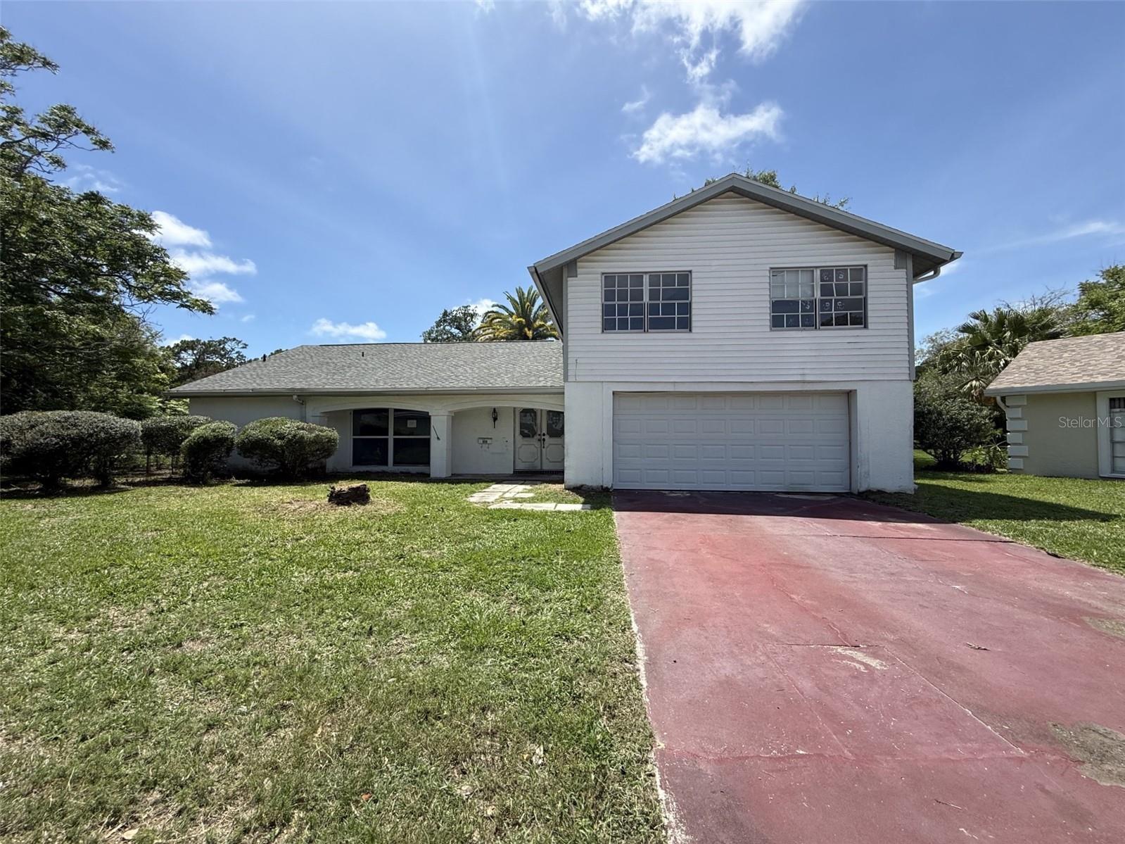 Opportunity awaits in Beacon Woods! This spacious 4-bedroom, 3-bathroom home offers over 2,000 square feet of living space and a desirable pond-front setting with peaceful water views. The functional floor plan features multiple living and dining areas, providing flexibility for a variety of lifestyles. The generous primary suite includes a private bath, walk-in closet, and access to the lanai,  while the additional bedrooms offer ample space for family, guests, or a home office. Enjoy relaxing mornings and beautiful sunsets overlooking the pond from the screened lanai. The 2-car garage provides additional storage and convenience. Located in the established Beacon Woods community, residents enjoy access to community amenities including golf, parks, a pool, tennis courts, and a convenient location near shopping, dining, medical facilities, and the Gulf Coast beaches. Bring your vision and make this water view property your own. With its spacious layout, scenic views, and excellent location, this home offers outstanding potential. Per public records, this property has a stabilization/remediation done in 2005. Roof permit from 2020.