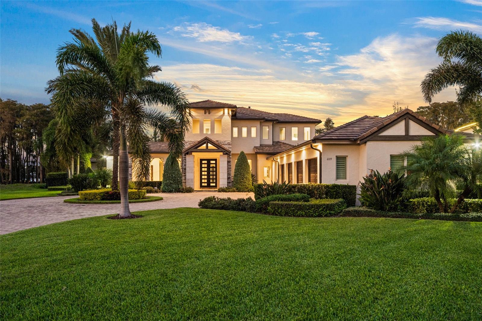 Within the gates of the Waterstone community, this exceptional lakefront estate offers approximately 5,895 square feet of refined living space, seamlessly blending modern elegance with timeless sophistication. The thoughtfully designed floor plan features five bedrooms, five full bathrooms, and two half bathrooms, with the primary suite conveniently located on the main level.
At the heart of the home is an expansive gourmet kitchen appointed with premium Thermador appliances and granite countertops, perfectly balancing form and function. The kitchen opens effortlessly to the grand family room, creating an ideal setting for both everyday living and entertaining. Soaring ceilings and clean, contemporary finishes throughout the residence underscore the home’s elevated design.
Additional highlights include a dedicated wine room, ideal for showcasing a curated collection, and a private office suite that offers a quiet, productive retreat. Outdoor living is equally impressive, featuring a resort-style pool and spa, an outdoor kitchen, and a fireplace—designed for year-round enjoyment.
Set on a generous 2.16-acre cul-de-sac lot, the property offers sweeping views of the ski-able Lake Cypress and includes a private dock capable of accommodating jet skis, delivering a truly exceptional waterfront lifestyle.