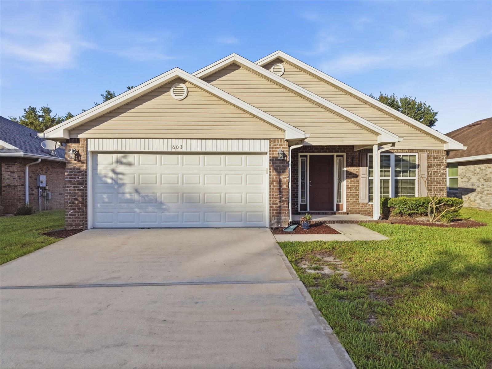 Virtually Staged. Tucked inside the gated community of Coral Trace, this 3-bedroom, 2-bath home offers comfortable Florida living with a thoughtful single-story layout, 2-car garage, screened back porch, and fenced yard. Inside, updated flooring, neutral finishes, and practical living spaces create a welcoming setting for everyday living. Coral Trace features a community pool and clubhouse, along with a convenient Edgewater location near I-95, shopping, dining, medical services, schools, boat ramps, the Intracoastal Waterway, New Smyrna Beach, and area beaches. A wonderful opportunity to own in an established neighborhood at an attractive price point.