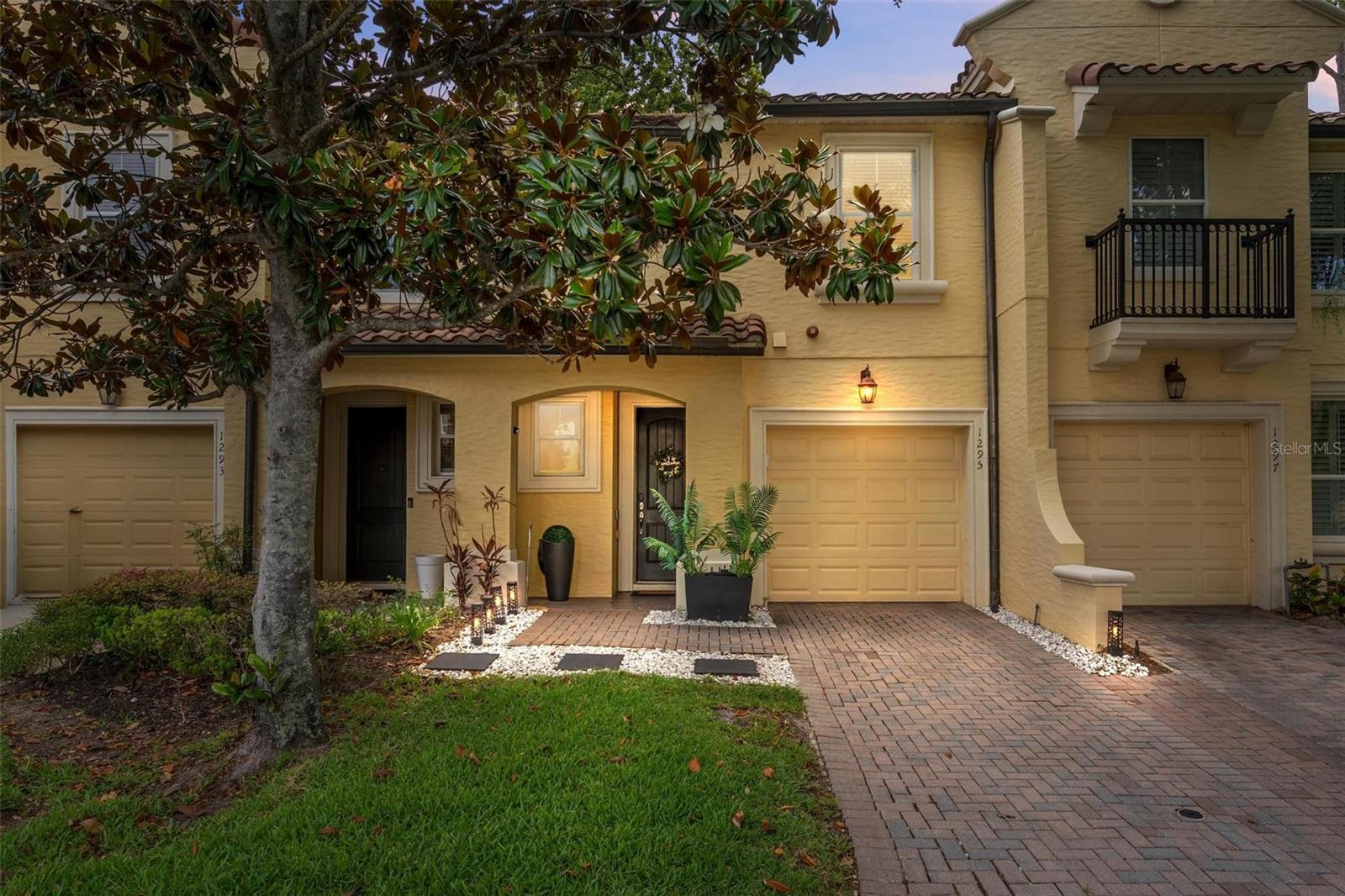 Nestled within the exclusive gated lakeside community of Montacino, this impeccably maintained Spanish/Mediterranean-inspired townhome offers refined living surrounded by serene natural beauty. The sought-after two-story Barclay model features an elegant open-concept design, seamlessly blending the spacious great room, dining area, and well-appointed kitchen—thoughtfully designed for both everyday comfort and effortless entertaining.

The chef-inspired kitchen showcases rich wood cabinetry, stainless steel appliances with upgraded microwave and dishwasher. The refrigerator and oven to be replaced with Stainless steel appliances by the sellers prior to closing. Expansive windows invite in abundant natural light while framing picturesque views of the lush green space beyond. Step outside to the covered rear patio and enjoy the rare privacy and tranquility of the only Barclay unit in the community backing directly onto this beautiful preserve-like setting, enhanced by custom patio pavers added in 2024.

Thoughtful updates throughout the home create a move-in-ready experience. The interior was refreshed with modern gray paint, kitchen and bathroom cabinetry were updated. The Stone countertops were updated with a beautiful Carrera style epoxy in the kitchen and baths, and the primary shower frame was refinished. Smart-home enhancements include Alexa-compatible light switches in the kitchen and primary bedroom, an upgraded alarm system, and a Ring doorbell. All three toilets have been upgraded, along with updated bathroom fixtures including shower rods and accessories.

Enhancing the home’s elevated design, the entire first floor features stunning premium oversized luxury vinyl plank flooring, offering both timeless style and durability. Upstairs, the expansive primary suite serves as a peaceful retreat, complete with a generous walk-in closet and a charming private balcony overlooking the greenery beyond. The luxurious en-suite bath features dual vanities and ample room to unwind. Two additional bedrooms, a full secondary bath, and a conveniently located laundry closet complete the second level.

Additional highlights include a newer HVAC system, crown molding throughout, engineered hardwood flooring across the second floor, and a one-car garage.

Residents of Montacino enjoy access to a sparkling resort-style pool and the scenic beauty of Lake Charity, all while being ideally located just minutes from I-4, premier dining, shopping, and the very best of Orlando living.