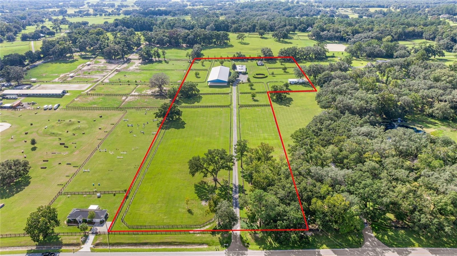 Under contract-accepting backup offers. Luxury equestrian estate - Ocala, Florida set along Ocala's most sought-after corridor, "Millionaire's Row" (225A), this 12-acre farm offers an unparalleled combination of location, beauty, and equestrian amenities.  Majestic granddaddy oaks and manicured grounds create a stunning backdrop for a turnkey property designed for the serious equestrian. The centerpiece is an 11-stall center aisle barn with fully matted stalls and aisle, a lounge/bedroom with full bath and kitchenette, 2 grooming/wash bays with hot water, a climate-controlled tack room with washer and drier, and a climate-controlled feed room with refrigerator plus a private office. Every detail has been considered for comfort, efficiency, and horse care at the highest level.  Training and competition preparation are elevated with a covered dressage arena featuring mirrors and Future Track footing plus full dressage letters and ring rails.  There is ample space for a jump field, and the property also includes a round pen plus an additional storage building which has 2 additional stalls and tack room.  Residential accommodations include a charming and spotless 2-bedroom, 1 bath cottage with laundry. A private, gated entry offers security and privacy. Located just minutes from the World Equestrian Center, HITS, and downtown Ocala, this property combines the serenity of 225A with immediate access to world class competition, dining and services. This estate delivers the rare opportunity to own a truly turnkey facility in the heart of the Horse Capitol of the World.