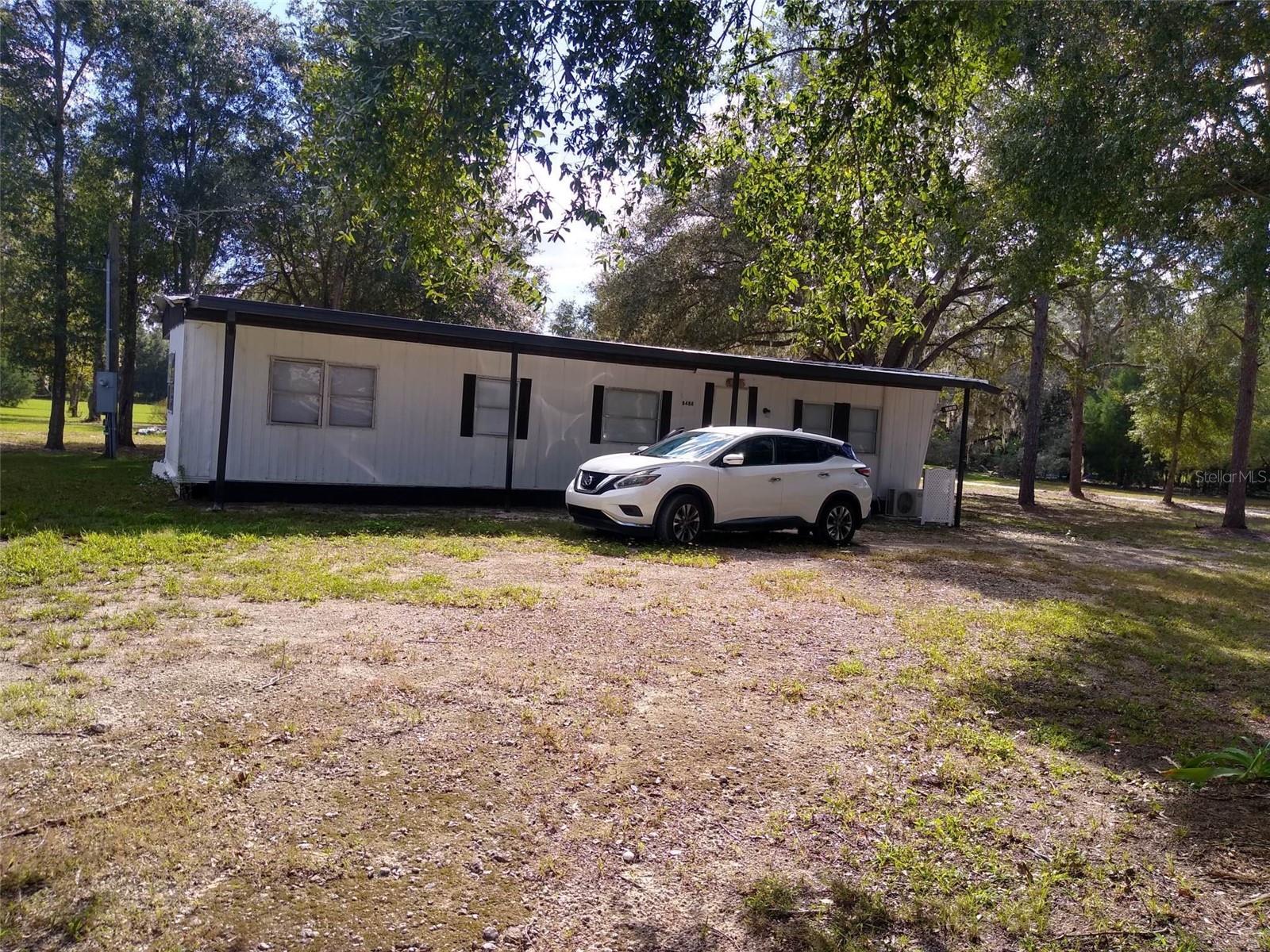 Nestled on 2.5 private acres, this charming 2-bedroom, 2-bath manufactured home offers the perfect combination of peaceful country living and convenience. Features include 1,056 sq. ft., updated bathrooms, vinyl laminate flooring, fresh interior and exterior paint, a covered front porch, gated entrance, private well and septic, and ample parking. Enjoy beautiful wooded views while being just minutes from shopping, dining, and major roadways. The spacious lot offers endless possibilities and, subject to county approvals, may provide the opportunity to build your future dream home. No HOA. Schedule your private showing today!