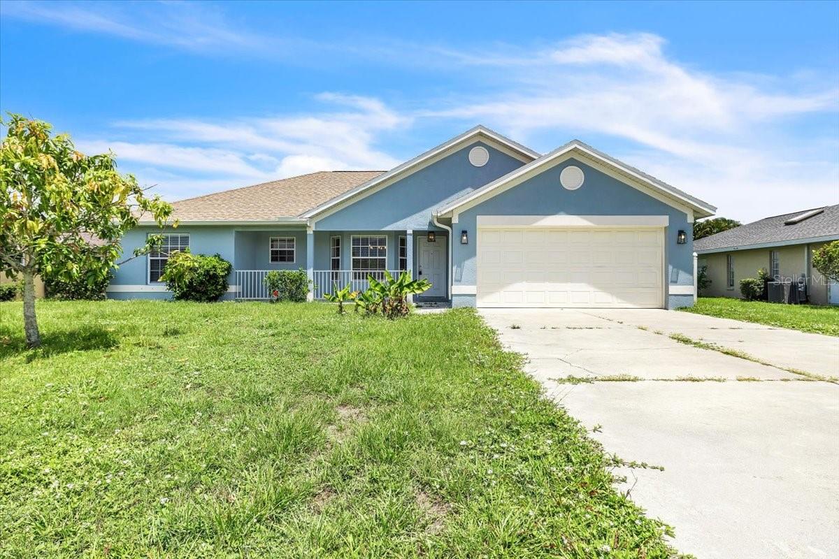 Welcome to this inviting 3-bedroom, 2-bathroom home in the highly sought-after community of Deep Creek, where comfort, style, and convenience come together in a desirable Florida setting. Attractive curb appeal welcomes you with a covered front porch, attached 2-car garage, and a spacious yard offering plenty of opportunity for landscaping and outdoor enjoyment. An extended driveway provides ample parking, while the home's classic design creates a warm and inviting first impression. Step inside to discover a bright and airy open-concept floor plan enhanced by all-new flooring, fresh interior paint, soaring vaulted ceilings, and abundant natural light. Designed with a desirable split-bedroom layout, this home offers the perfect balance of comfortable gathering spaces and private retreats. At the heart of the home, the spacious kitchen overlooks the living and dining areas, making entertaining effortless. Features include granite countertops, stainless steel appliances, abundant white cabinetry, and a convenient breakfast bar ideal for casual dining or hosting guests. Large windows and vaulted ceilings enhance the great room's open feel, while beautiful wood-look flooring adds warmth and style throughout the main living areas. The privately situated primary suite serves as a relaxing retreat, complete with a walk-in closet and an en-suite bathroom featuring a dual-sink vanity and tub/shower combination. Two additional bedrooms, each with built-in closets, provide flexibility for family, guests, a home office, fitness room, hobby space, or den. A full guest bathroom is conveniently located nearby. Adding to the home's appeal are an indoor laundry room, attached 2-car garage, hurricane shutters, a new roof (2022), and a new water heater (2023), offering valuable peace of mind for years to come. Step outside to a fully fenced backyard featuring a screened lanai, the perfect place to relax, entertain, or enjoy Florida's beautiful weather year-round. Located in Deep Creek Section 23, residents enjoy a quiet, deed-restricted community with low annual HOA fees, scenic greenbelt views, freshwater lakes, and desirable amenities including public tennis courts, a playground, and the popular Deep Creek Golf Club featuring an 18-hole championship course, practice facilities, and clubhouse. Conveniently situated near Deep Creek Elementary School, shopping, dining, churches, and everyday essentials along Kings Highway and US-41, this home also offers quick access to I-75. Historic downtown Punta Gorda, Fishermen's Village, waterfront parks, marinas, and Gulf beaches are all within easy reach, providing the perfect balance of peaceful neighborhood living and convenient access to Southwest Florida's premier attractions.