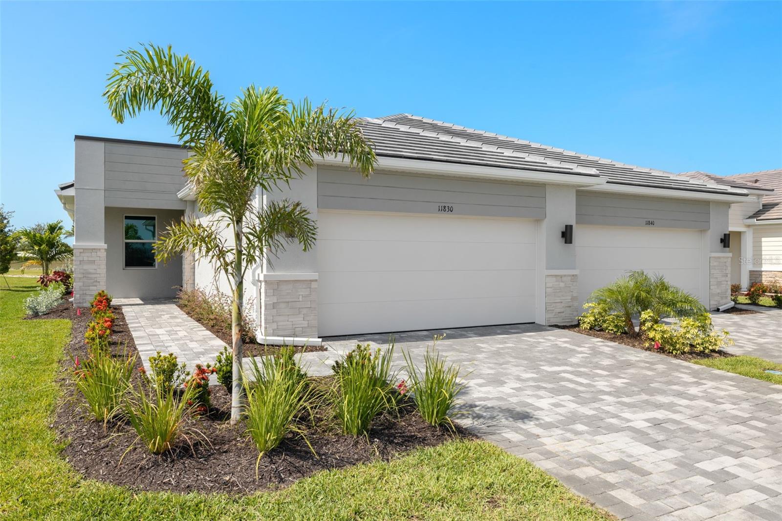 Under Construction. Step into effortless Florida living with this beautifully designed Maya villa with a Transitional elevation in the highly desirable 55+ community of Brightmore, where an open-concept layout welcomes you with natural light pouring through a high great room window and expansive sliding glass doors that lead to a screened lanai—perfect for enjoying peaceful mornings or entertaining guests; the kitchen is a true focal point, featuring elegant off-white quartz countertops with delicate gray veining, warm-toned cabinetry with soft-close doors and drawers, crown molding, a stylish tile backsplash, and a full suite of stainless steel appliances including an ENERGY STAR® refrigerator, while tile flooring flows throughout the main living areas and plush carpeting adds comfort to the bedrooms; the spacious owner’s suite offers a serene retreat with dual sinks and a beautifully tiled shower, complemented by a secondary bathroom with a sleek recessed shower, plus a versatile flex room with an oversized 8-foot door, impact windows, a pre-plumbed garage utility tub, and a washer and dryer included for added convenience; beyond the home, Brightmore delivers an exceptional resort-style lifestyle with a stunning clubhouse at its heart featuring in-house dining and a bar, perfect for gathering with neighbors, along with a dedicated lifestyle director who curates a full calendar of social events and activities, a resort-style pool with relaxing lounge areas, scenic walking paths, and popular pickleball courts that serve as a lively hub for both friendly matches and competitive play, all ideally located near shopping, dining, and the beautiful Gulf Coast beaches.
*** Photos, renderings and plans are for illustrative purposes only and should never be relied upon and may vary from the actual home. Pricing, dimensions and features can change at any time without notice or obligation. The photos may be from a furnished model home and not the home offered for sale.