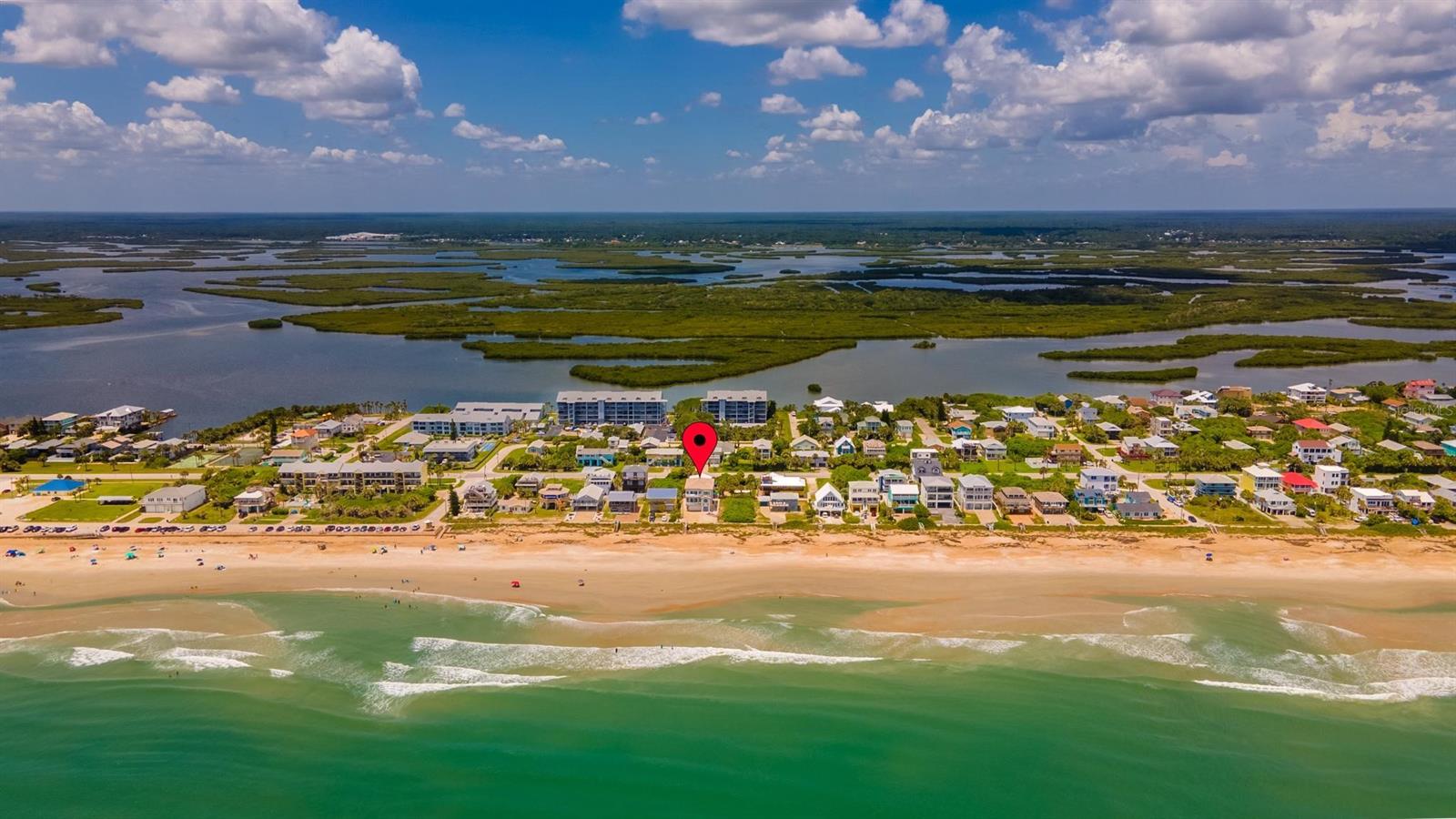 Oceanfront 7 bedroom, 4 bath home with room for everyone.  Step out your door and over your private beach walkover to enjoy the surf and sand any time of the day or night.  Rise early to enjoy the fabulous sunrise.  See turtles dig their nests and their babies hatch. Impact glass windows and sliders provide amazing views up and down the beach.  Sweeping staircase leads to main living level open floorplan with spacious rooms, high ceilings, a granite and stainless kitchen with breakfast bar, large great room with plentiful dining and living room seating and balcony.  There are also 2 guest bedrooms and a renovated bath on this level.  Head up the stairs and the wide hallway to enter the private oceanfront master suite with two walk in closets, lounge and exercise space, along with master bath featuring under mount sinks, walk-in shower and jetted tub.  A double set of sliders to take in the views both up and down the beach from this suite and its private balcony.  There are 2 more bedrooms and bath with under mount sinks and walk in shower as well as a laundry room on this level.  The first floor features an in-law suite with separate entrance, 2 additional bedrooms and bath, living room, kitchen and another laundry room.  LED lighting throughout.  Wind rated windows and turtle glass.  Wired for a whole house generator.  Roof 2017.  Three 2019 HVAC units with nest thermostats.  Main water heater is 2015.  Two car garage with 220 electric vehicle charging station plus plenty of additional parking in the deep driveway plus space in the shell yard for the times you invite all your friends to join you for a play date at the beach!  The lifeguard tower is at the end of the street and County park riverfront pier, volley ball, basketball and pickleball courts are just a couple of blocks away. ;Water: City