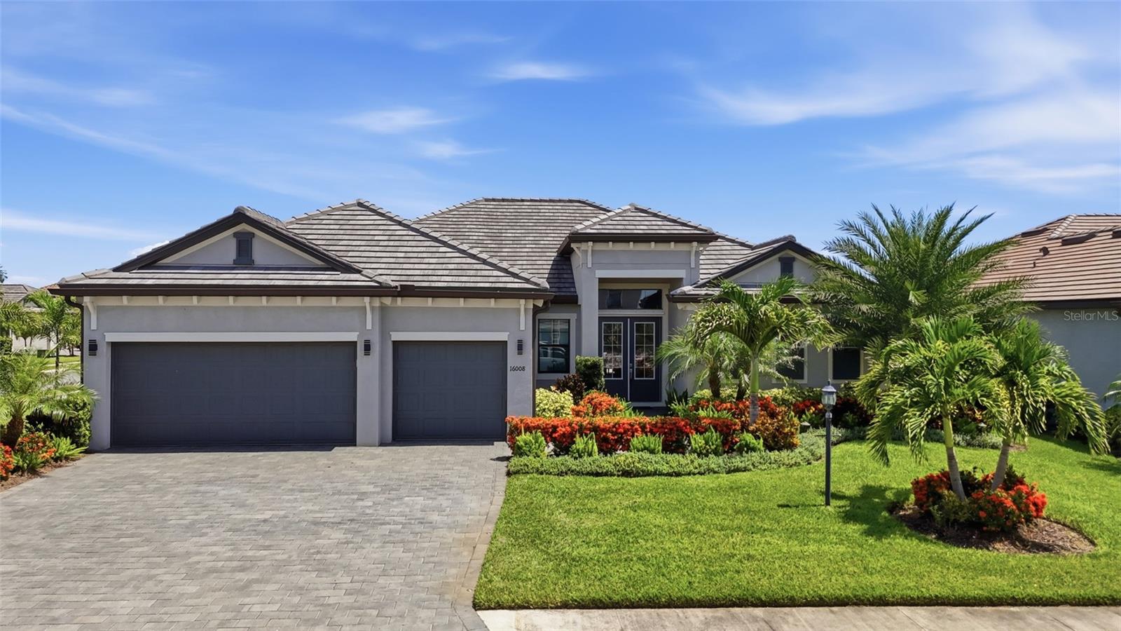 Experience resort-style living at its finest in this exceptional luxury residence located within the prestigious gated community of Lorraine Lakes at Lakewood Ranch. Perfectly positioned on an oversized corner lot, this meticulously designed 2022 home offers 4 bedrooms, 3 bathrooms, and a 3-car garage, showcasing refined finishes, soaring architectural details, and seamless indoor-outdoor living. Featuring a durable 2022 tile roof, two private suites, an expansive heated pool and spa, and access to world-class resort amenities, this home offers an unparalleled Florida lifestyle.

INTERIOR FEATURES:
• 4 bedrooms, 3 bathrooms, 3-car garage
• Built in 2022
• 2022 tile roof
• Gas tankless water heater
• Oversized corner lot
• Bright, open-concept floor plan
• Soaring coffered and tray ceilings
• Crown molding throughout
• Tile flooring throughout the home
• Two private suites
• Spacious living room with oversized pocket sliding glass doors
• Designed for effortless entertaining and everyday luxury.

GOURMET KITCHEN:
• Stainless steel appliances w- "Sub-Zero" refigerator
• Gas cooktop
• Built-in wall oven and microwave
• Quartz countertops
• Tiled backsplash
• Oversized center island with breakfast bar
• Closet pantry
• Open to the living and dining areas
• Dining room with sliding glass doors to the lanai

PRIMARY OWNER'S SUITE:
• Spacious primary bedroom
• Private sliding glass doors to the lanai
• Dual walk-in closets
• Luxurious en-suite bathroom
• Dual sink vanity
• Oversized walk-in shower
• Private water closet

GUEST SUITES & FLEX SPACE:
• Split-bedroom floor plan for maximum privacy
• Private second suite with walk-in closet
• En-suite bathroom with direct lanai access—ideal as a future pool bath
• Third guest bedroom with built-in closet
• Spacious flex room serving as a fourth bedroom, home office, media room, or den
• Additional full guest bathroom

OUTDOOR LIVING:
• Expansive screened paver lanai
• Oversized heated swimming pool and spa
• Sun shelf perfect for lounging and relaxing
• Beautifully landscaped for exceptional privacy
• Ample covered and open-air entertaining space
• Peaceful setting ideal for relaxing or hosting family and friends

RESORT AMENITIES – LORRAINE LAKES:
• Prestigious gated community
• Resort-style clubhouse
• Multiple resort-style pools
• Splash pad
• Poolside restaurant and bar
• State-of-the-art fitness center
• Game room
• Tennis courts
• Pickleball courts
• Basketball court
• Sand volleyball court
• Bocce ball courts
• Putting green
• Playground
• Community park
• Scenic lakes
• Walking and biking trails

LOCATION HIGHLIGHTS:
• Located in the highly sought-after Lakewood Ranch master-planned community
• Minutes from shopping, fine dining, and entertainment
• Close to championship golf courses
• Near top-rated schools and medical facilities
• Short drive to Waterside Place, UTC Mall, downtown Sarasota, and the Gulf Coast's award-winning beaches

From its elegant architectural details and thoughtfully designed floor plan to its private backyard oasis and unmatched resort-style amenities, this exceptional residence embodies luxury living in one of Southwest Florida's most coveted communities. Whether entertaining beside the heated pool and spa, relaxing on the sun shelf, or enjoying the vibrant lifestyle of Lorraine Lakes, this remarkable home offers the very best of Lakewood Ranch living. Schedule your private showing today!