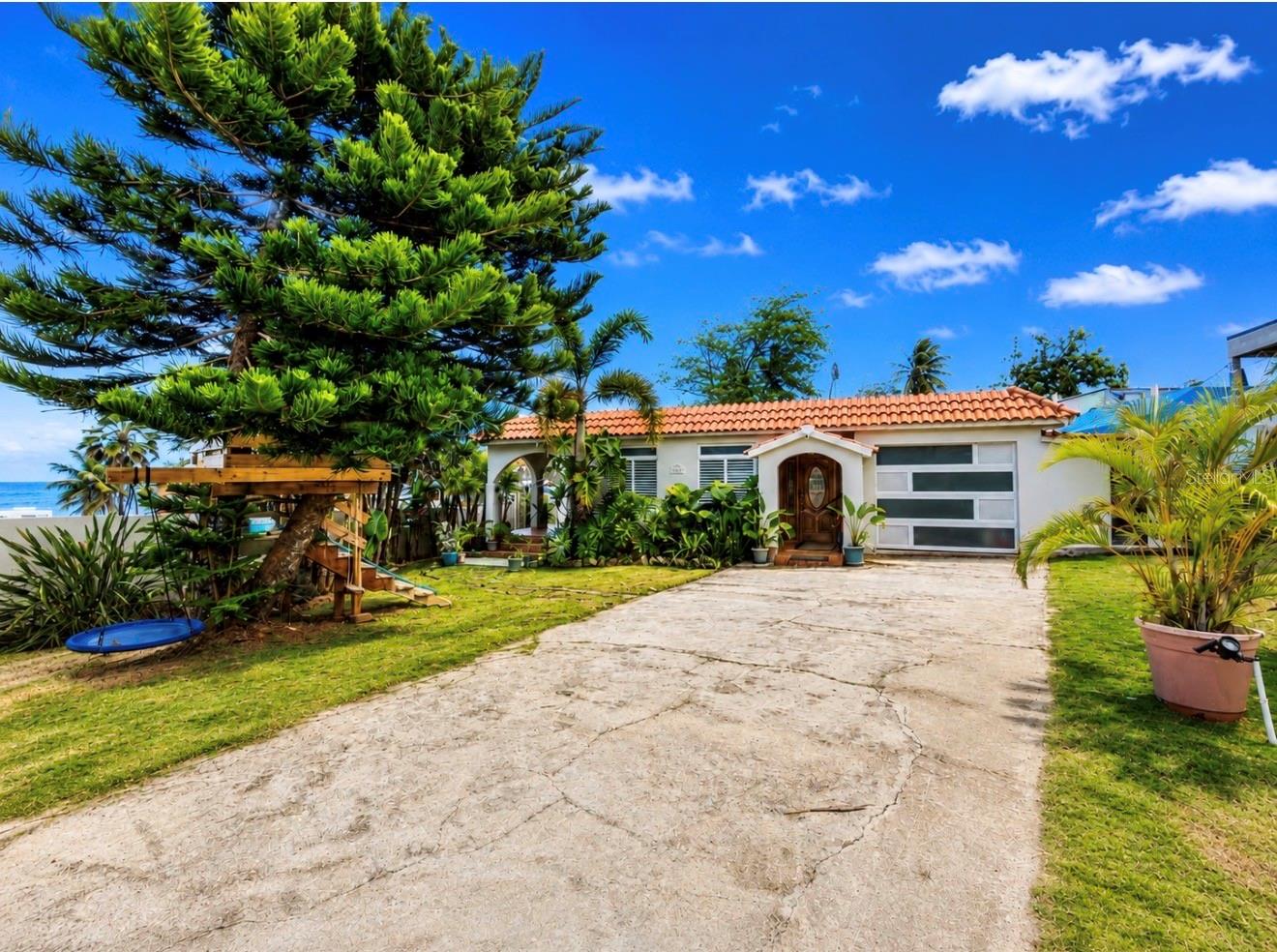 Wake up and walk to the beach. This charming 2BD/2BA Spanish colonial home sits just steps from the Atlantic in Dorado's sought-after Barrio Mameyal — one of Puerto Rico's most beloved beachside neighborhoods. Grab your board and hit the waves in minutes, as the area is known for some of Puerto Rico's best surfing spots right on the North Coast. Spend your mornings riding waves and your evenings unwinding on a stunning covered arcade terrace with sweeping ocean breezes. Set on an expansive 833 m² lot with lush tropical landscaping, this is more than a home — it's a surfer's paradise. Whether you're looking for a primary residence, vacation retreat, or investment property, opportunities this close to the water in Dorado don't come around often. Surf, sun, and sand — every single day.

Appliances Included: Microwave, Linear Water Heater, 2 Split Unit Air Conditioners