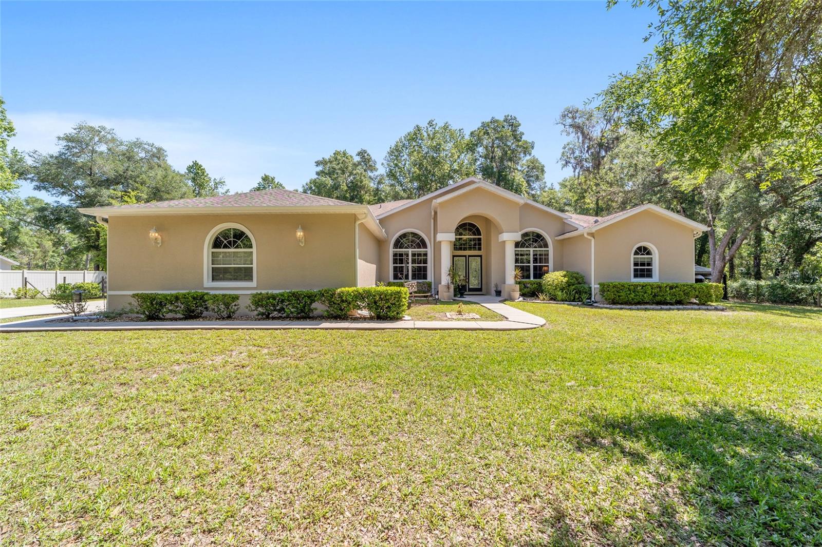 Assumable mortgage loan with approximately $248,000 balance left at 3.25 interest rate for qualified buyer. Welcome to this private one-acre residence in Inverness, offering a thoughtful balance of space, functionality and access to the Nature Coast lifestyle. This three-bedroom home with a dedicated office and two baths is set on a wooded homesite that provides natural separation and a quiet setting. The interior features a well-appointed kitchen with solid-surface countertops, tile backsplash, high-end appliances, white cabinetry and a large center island with storage. Flooring includes ceramic tile throughout the main living areas, with beautiful real wood flooring in the primary bedroom, supporting durability and ease of maintenance. Outdoor living is designed for year-round use. The fenced backyard accommodates pets and gatherings, while the above-ground pool and screened-in lanai create defined areas for dining and relaxation. A large concrete patio extends the outdoor space for grilling and entertaining, complemented by a waterfall feature that serves as a focal point within the landscape. An air-conditioned detached large shed (14 by 24 feet) offers flexible space suitable for a workspace, studio or additional storage. A hidden gem just moments from Fort Cooper State Park. This residence offers a rare living-in-the-park experience, characterized by majestic oak trees and daily wildlife visits. It is a sanctuary for those seeking a relaxed pace within Florida’s Nature Coast, whether as a full-time residence or a seasonal retreat. The home seamlessly combines privacy and modern convenience, featuring a spacious layout and purposeful outdoor living areas designed to embrace its natural surroundings. While the property feels worlds away, you remain ideally connected, just five miles from vibrant shopping, dining and community events of Inverness. Adventure is always within reach with local kayaking and canoeing, plus world-class boating, fishing and scalloping in nearby Crystal River. Additionally, the Suncoast Parkway (589) extension ensures seamless regional access, placing Tampa International Airport less than one hour away. Buyer must qualify with bank for assumable loan.