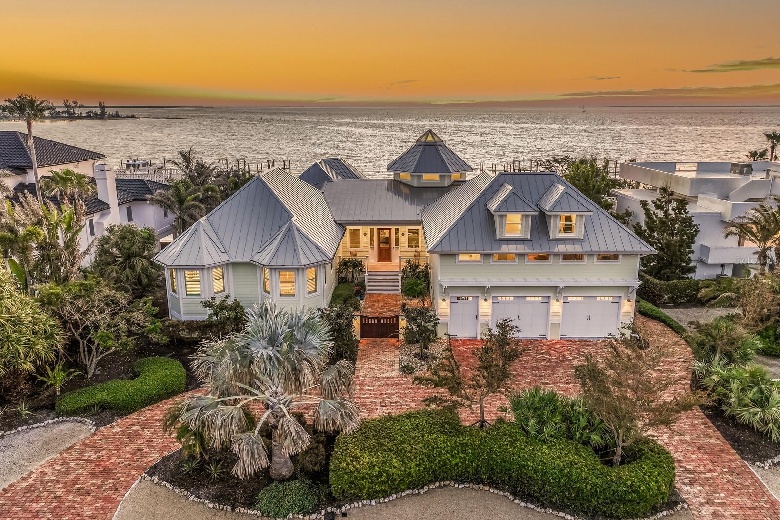 Under contract-accepting backup offers. Experience the pinnacle of coastal luxury in this waterfront estate home located in the exclusive, gated Boca Grande Isles neighborhood. Offering four bedrooms, five and a half baths, and 4,540 square feet of refined living space, this residence blends tasteful design with premier craftsmanship.

Extensively renovated in 2018, with a meticulous two year transformation, the home lives like new while maintaining timeless architectural character. Enhanced with Hurricane Impact windows and sliding glass doors, Ipe decking, and cement board siding, the property offers both beauty and peace of mind, with materials selected for durability, resilience, and low-maintenance. Designed for both day to day living and effortless entertaining, the home showcases an open concept kitchen, dining, and living area with sweeping waterfront vistas. The gourmet kitchen includes high end appliances, generous counter space, and a large walk-in pantry, perfect for the culinary enthusiast. The thoughtful interior layout ensures exceptional owner privacy, even when hosting guests. The expansive Primary suite serves as a serene retreat, featuring breathtaking sunrise views over Charlotte Harbor. Each oversized guest bedroom includes its own ensuite bath, providing both comfort and luxury for family and friends. A spacious bonus room with a wet bar and full bathroom offers remarkable flexibility and can easily transform into a fifth bedroom, office, media or fitness room. The outdoor living space emulates the interior space with an infinity edge pool, elevated decks for uninterrupted water views and multiple lounging areas for relaxing. Additional features include a large two car garage designed to accommodate vehicles and a golf cart, complete with a sizable storage closet for fishing and beach gear.

Located just a short golf cart ride from the charming Boca Grande Village, you will enjoy convenient access to boutique shopping and acclaimed restaurants. The island’s beautiful sandy beaches are also just moments away, completing the quintessential Boca Grande lifestyle.
From the refined interior to peaceful water views and unbeatable proximity to island amenities, this estate offers an extraordinary opportunity to own a premier home on Boca Grande.