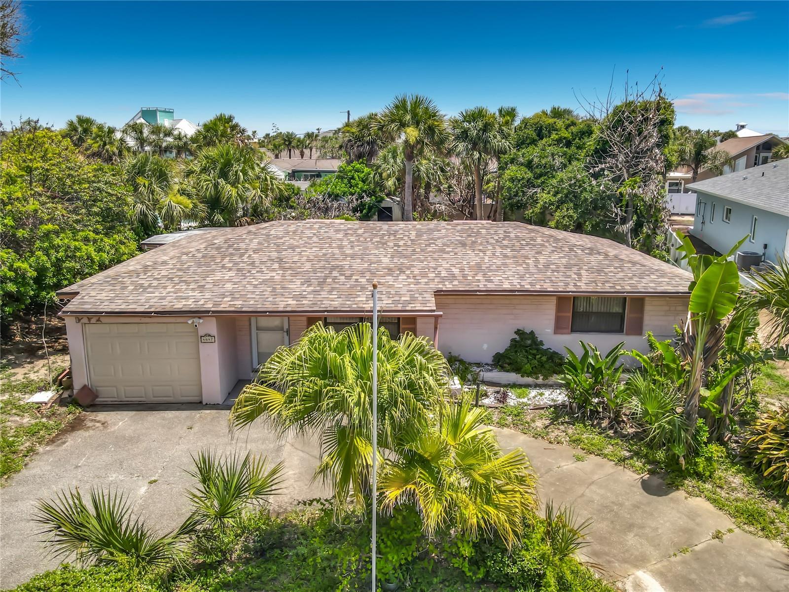Nestled in the desirable Silver Sands community of beachside New Smyrna Beach, this charming 2-bedroom, 1-bath concrete block home offers the perfect blend of coastal living and opportunity. Situated on a spacious quarter-acre lot, this property is located between the Indian River and the Atlantic Ocean, just minutes from the beach, shopping, dining, and all that New Smyrna Beach has to offer. Inside, you'll find an open living area, terrazzo flooring, central air conditioning, and kitchen equipped with a cooktop, dishwasher, microwave, refrigerator, and disposal. The primary bedroom features a walk-in closet, while sliding glass doors provide easy access to the expansive backyard. A one-car attached garage offers additional storage and convenience. Whether you're looking for a primary residence, vacation getaway, investment property, or a site to build your dream beachside retreat, this property offers endless potential in a highly sought-after location. Don't miss this opportunity to own a piece of paradise just moments from the ocean and river.