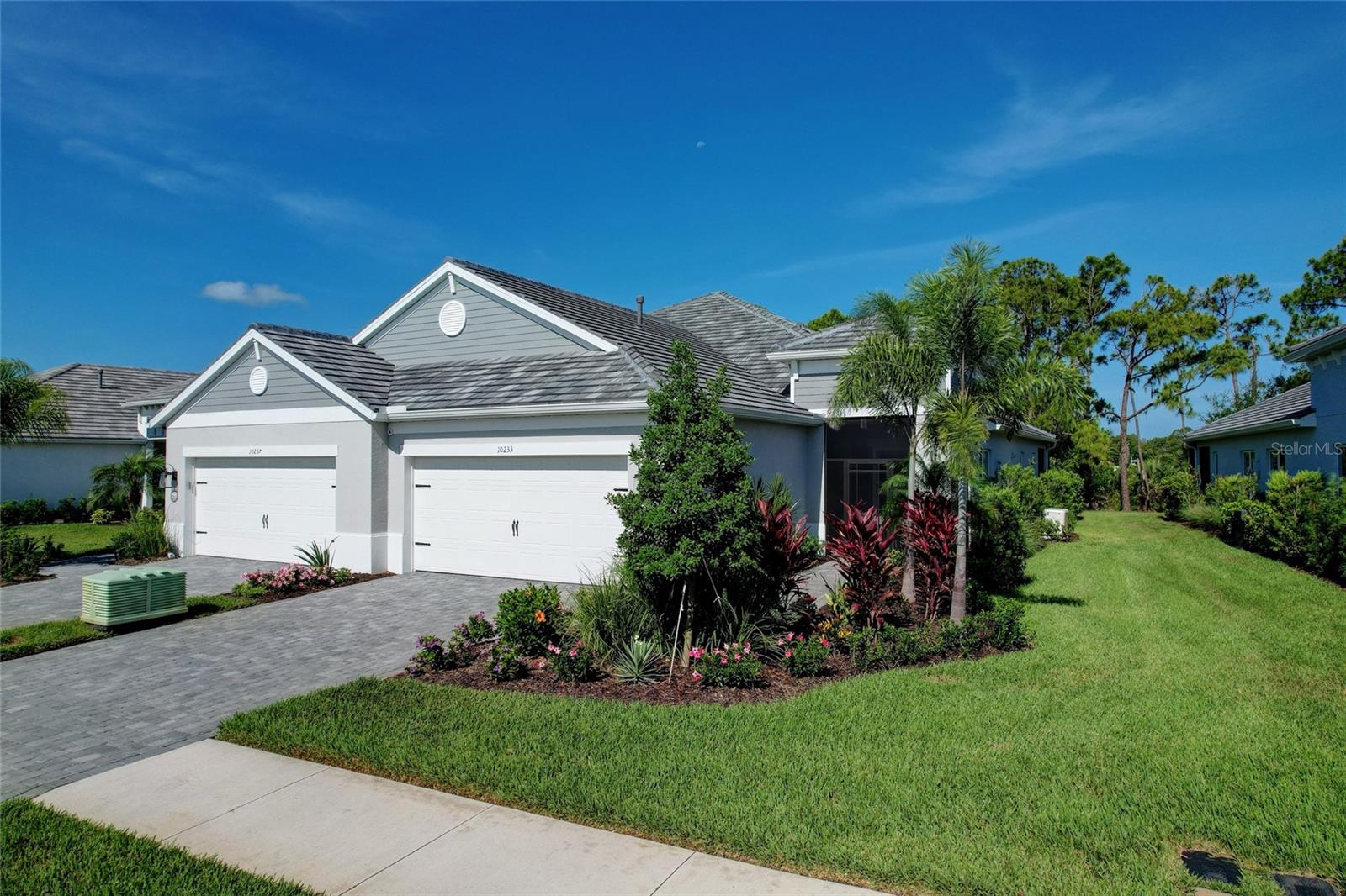 Rare Neal Homes Villa presents a unique opportunity to own a piece of luxury nestled in the exclusive Sold-out gated Villa Community of Grand Park, Sarasota. Everything is done for you. With low HOA fees & Fantastic Community Amenities. This beautiful villa boasts tons of beautiful upgrades and high-end fixtures. Starting with solid concrete block construction, full tile roof, whole-house natural gas generator, updated hurricane impact windows and upgraded triple pocket sliders. The two spacious bedrooms plus office/den with French doors includes upgraded tiled floors that extend throughout the entire home. A custom tray ceiling in the great room features stained wood 12-foot ceiling beams, a solid high end wood ceiling fan, upgraded 8-foot doors throughout, and elegant high-end designer lighting and ceiling fans. A custom built-in bar with a wine refrigerator adds a touch of elegance, while stylish architectural brick wall, wainscotting, and walnut wood wall features highlight the luxurious finishes expected in this level of home. Plantation shutters were added on every window as well as a custom honeycomb cellular shade on the triple sliders, custom his and hers closets with 8-foot glass barn doors provide organized storage in the primary. The well-appointed kitchen features shaker soft-close cabinets, two 36-inch upgraded glass door cabinets, and two sets of triple-stack pot drawers. The seamless quartz countertops highlight a beautiful center island with a large stainless steel single bowl sink. New stainless-steel appliances, including an upgraded slide-in gas range with air fryer and upgraded counter-depth refrigerator are included. There is a large walk-in pantry with an upgraded 8-foot glass door providing additional storage space that completes the kitchen area.  The guest bedroom includes a new (never used) queen size Murphy bed. The laundry room includes a new washer and gas dryer with added cabinet storage, laundry sink and upgraded faucet.  Relax on your extended brick paver lanai while enjoying the protected conservation and nature views. Observe wildlife such as deer and cranes roaming within this park-like setting. The professionally landscaped property includes micro drip irrigation to all plants and trees, and high-end landscape and path lighting that illuminates the exterior surroundings. The front brick paver driveway leads to an upgraded screened porch, while the oversized two-car garage boasts high ceilings & epoxy floors. The garage features include high-end diamond plate storage cabinets, a workstation, and two 4ft x 8ft overhead storage racks. This eliminates the need for any attic storage. Additionally, there is a new upgraded top-of-the-line whole house Kinetico Water filtration and water softener system.  Grand Park is a nature-focused, resort-style Maintenance free community with plenty of open space with miles of conservation walking & biking trails. You love strolling around the lakes and discovering the abundance of nature sharing this beautifully planned community.  Amenities include an active clubhouse with full-time social director, resort-style tropical pools, full fitness center, pickleball and tennis courts, and two dog parks all a short walk from your new home. Easy access to shopping, dining, nearby beach's including the #1 beach in America Siesta key beach. And you're a short ride to downtown Sarasota's comedy clubs, cultural events and active downtown entertainment. The only thing missing is you