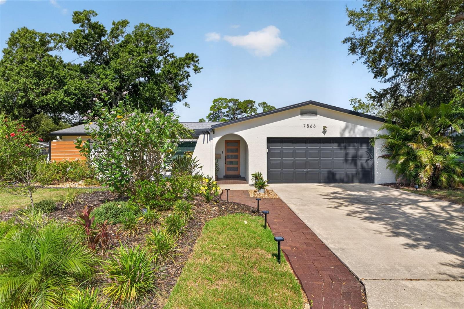 Welcome to a home that feels as amazing as it looks. Nestled in the desirable Meadowlawn neighborhood, this beautifully updated 3-bedroom, 2-bathroom residence offers the perfect balance of thoughtful design, modern updates, and inviting spaces made for everyday living and effortless entertaining.

At the heart of the home is a true entertainer's kitchen, where concrete countertops, updated appliances, abundant cabinetry, and generous prep space create the ideal setting for everything from casual breakfasts to holiday gatherings. The open flow into the living spaces makes hosting family and friends feel natural.

When it's time to unwind, gather around the stunning mid-century modern Malm Zircon wood-burning fireplace, a striking centerpiece that brings warmth, character, and the perfect ambiance on cool Florida evenings. The home also features both a formal living room and a separate family room, giving everyone space to spread out. A built-in Murphy bed transforms the family room into a comfortable private guest retreat whenever needed. Simply close the barn doors. 

The thoughtfully designed split floor plan places the spacious primary suite on its own side of the home, complete with an ensuite bathroom for added privacy. Throughout the home you'll find durable tile and luxury vinyl plank flooring with no carpet to maintain.

Step outside and discover your own backyard oasis. Spend sunny afternoons relaxing in the sparkling in-ground pool, rinse off in the outdoor shower after a swim, or enjoy morning coffee and evening cocktails beneath the covered patio, rain or shine.

Beyond the beautiful finishes, this home offers valuable peace-of-mind updates, including hurricane impact windows, a 2022 roof, and a complete re-plumbing. A spacious two-car garage provides additional storage and convenience.

Combining timeless mid-century charm with modern improvements and exceptional indoor-outdoor living, this Meadowlawn home is ready for its next chapter.