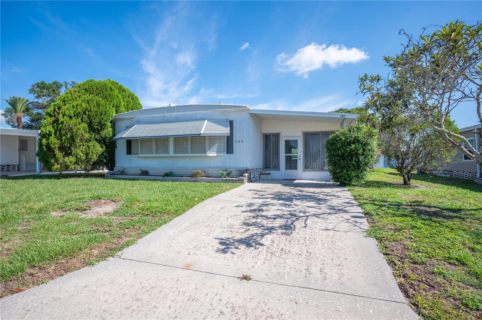 What if your next move meant more living? Steps from the Citrus Woods clubhouse and heated pool sits a 2-bedroom, 2-bath home that's been loved by the same family for years, and it shows. It comes fully furnished, so you can arrive with a suitcase and start living. Best of all, you own the land, no lot rent here. Picture morning coffee, then an easy walk to the pool, afternoons of shuffleboard, and time with neighbors at the clubhouse. Citrus Woods Estates is an active, pet-friendly 55+ community in the heart of Lakeland. At just $710 a year, the HOA covers the heated pool, shuffleboard, clubhouse, library, and nighttime Sheriff's Office security, with shopping, dining, and medical care minutes away. Schedule a showing today!