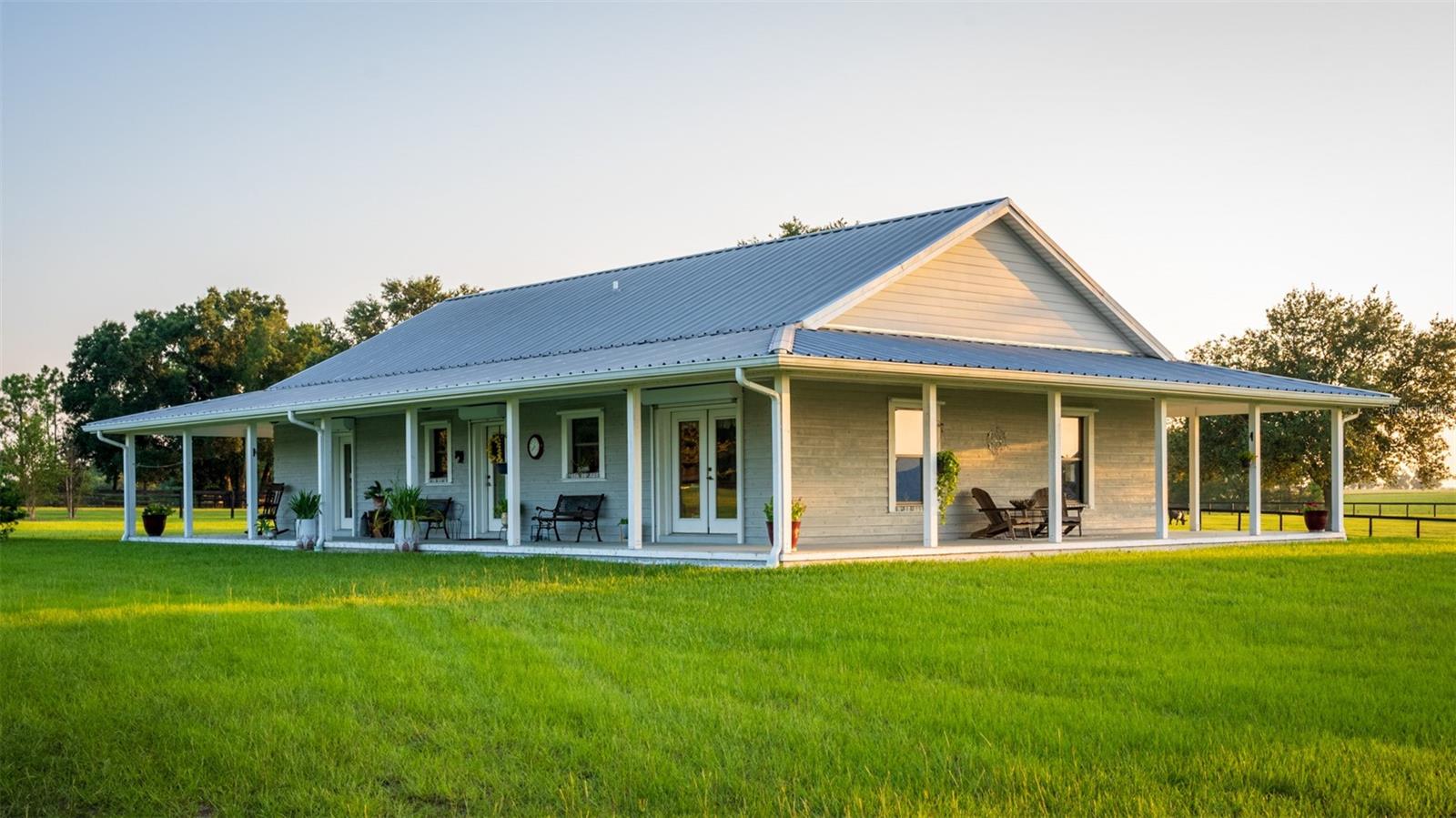 Aviators, Airplane Pilots, Horse Lovers, this is it! — Tucked away from the main road, this pristine and peaceful 19-acre farm is surrounded by hundreds of acres of woods and open fields, offering unmatched privacy and natural beauty. A true haven for animal lovers and aviation enthusiasts alike, with no HOA restrictions.

The charming custom-built concrete home is thoughtfully maintained and features 3 bedrooms, 2 bathrooms, a bonus room on the 2nd floor (not included in the sft), and a large welcoming wraparound porch—perfect for enjoying the serene surroundings and the exceptional Florida sunrises and sunsets.

Equestrian facilities include a well-appointed horse barn with two spacious stalls, two additional outdoor stalls, a tack room, hay room, and a full bathroom. Ride or train in the impressive 200 x 150 ft sand/clay arena overlooking a picturesque pond, while a gazebo provides the perfect spot to take in stunning sunrises and sunsets. The property is fully enclosed with durable Cryoboard fencing and includes three expansive paddocks equipped with automatic waterers for horses and livestock.

For Aviation and hobby enthusiasts, the insulated Airplane Hangar offers versatile space for aircraft, car collections, farm equipment, or recreational vehicles—complete with a dedicated “man cave” overlooking the impressive 2,700 x 250 ft private grass runway.

Additional highlights include two ponds, majestic old oak trees, and over 60 newly planted trees enhancing the landscape. All utilities are underground for a clean, unobstructed setting, and the property is designed for easy maintenance.

Ideally located just 15 minutes from HITS in Williston and 30 minutes from WEC and Ocala, this exceptional property blends rural charm, equestrian excellence, and private aviation into one extraordinary offering.
