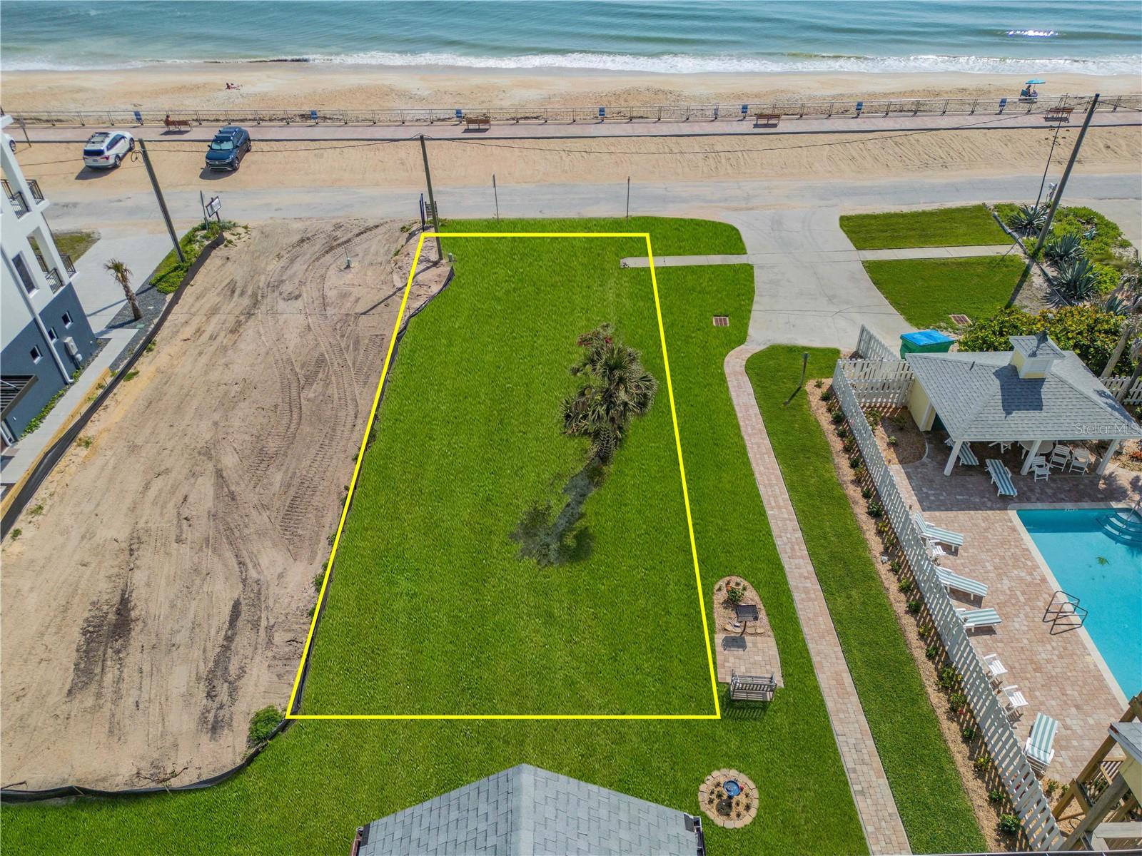 Presenting your dream-come-true of coastal living with this exceptional OCEAN-FRONT LOT, ideally located on the secluded, no-drive section of Bethune Beach. This tranquil stretch of shoreline lies between the unspoiled beauty of the Canaveral National Seashore and the vibrant charm of Flagler Avenue and Canal Street. Just a short stroll from the iconic JB’s Fish Camp, and only moments from Intracoastal boat ramps, boutique shopping, fine dining, and local entertainment, this property places you in the heart of Florida’s quintessential beachside lifestyle. Set among beautifully maintained, custom-built, multi-million dollar homes, this prime lot offers a rare opportunity to create a private beachfront retreat that embodies timeless coastal elegance. Best of all, it is NOT in a flood zone, is protected by a county-maintained seawall—providing both long-term value along with a staffed lifeguard stand providing peace of mind. Zoned Tourist B-8, the property allows for legal 30-day short-term rentals, making it not only a rare find but also a highly flexible investment opportunity—surrounded by luxury seaside homes.  Adding to its pedigree, the lot is currently owned by nationally renowned architect David Harper, described by Wikipedia as one of the "Most Notable Architects of the 21st Century" and the recipient of more than 20 awards for design excellence.  Mr. Harper has already crafted a breathtaking residence specifically for this site—an architectural statement that elevates everyday living into an art form, should you choose to bring it to life.  Whether you're seeking a peaceful escape, a luxurious vacation home, or a high-performing income property, this is your chance to own a truly unique piece of ocean-front paradise—where natural beauty, relaxed sophistication, and future potential converge.