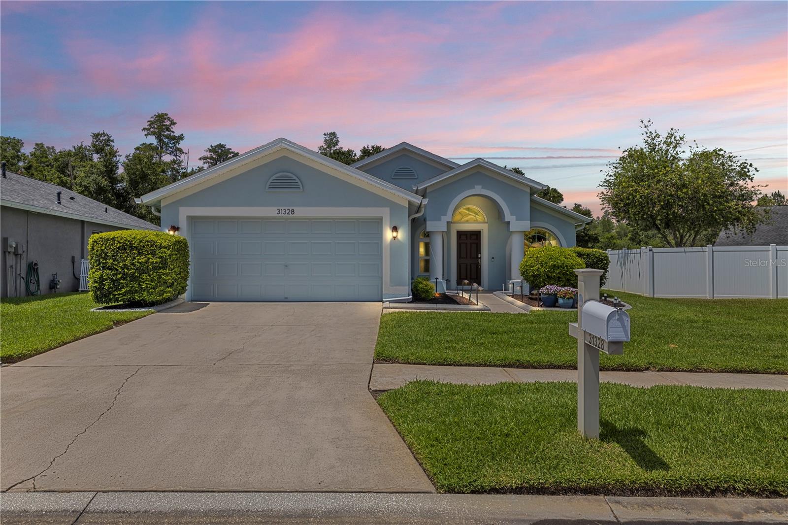 Welcome to Wrencrest, a gated community within Meadow Pointe! This beautifully updated 3-bedroom, 2-bathroom home with a 2-car garage offers 1,630 square feet of comfortable living space on a peaceful lot with a pond view and preserve directly behind the home. The home features a desirable split-bedroom floor plan with formal living and dining areas, a spacious family room, and a remodeled eat-in kitchen with soft-close doors and drawers, tile backsplash, matching quartz countertops, breakfast bar, breakfast nook, GE Café induction range, microwave, and dishwasher less than a year old. Wood-look tile flooring runs throughout the entire home, creating a clean and cohesive feel. The primary suite features a California Closets-designed walk-in closet and a beautifully remodeled bathroom with a large luxury shower, massive vanity with tons of storage, and matching quartz countertops. Additional updates include remodeled bathrooms, LG top-load washer and dryer less than a year old, brand-new roof with a 25-year transferable warranty, new soffits and gutters, new hurricane-rated impact windows and doors with transferable warranty, new interior and exterior paint, new hot water heater, epoxy garage floor, whole-house surge protector at the electrical box, Kinetico water softener and filtration system, and HVAC upgrades including a UV light for mold prevention and additional returns to help balance the temperature throughout the home. The exterior is just as impressive with a fenced backyard, covered patio overlooking the pond and preserve, landscape curbing, landscaping fabric in the planter areas to help prevent weeds, and landscape lighting throughout the front area. Window treatments, Ring alarm system, and Ring doorbell are also included in the sale. The home also offers the maximum homeowner’s policy discount from the wind mitigation inspection. Meadow Point residents enjoy access to multiple community centers, pools, tennis courts, playgrounds, and more. Aggressively priced for today’s market, this home offers an incredible opportunity to own a truly move-in-ready home in one of Wesley Chapel’s most desirable communities.