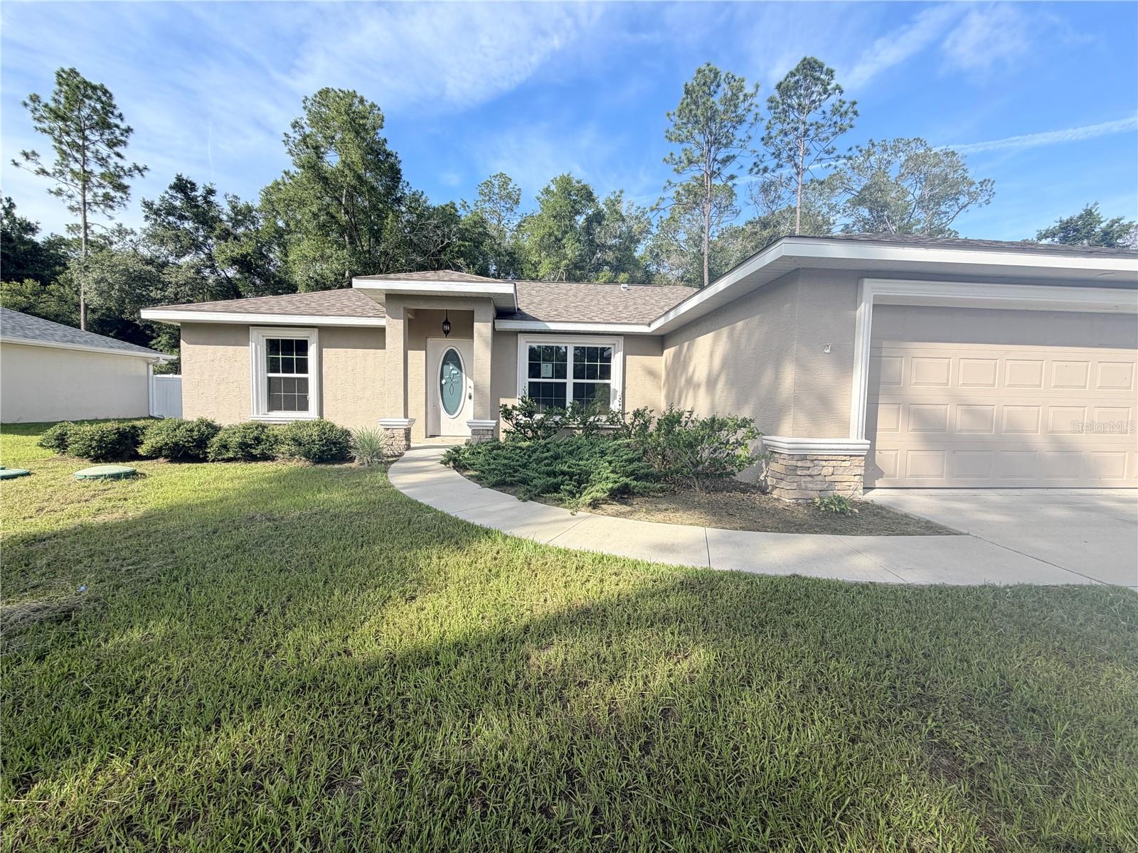 Welcome to 9850 N Sandree Dr, Citrus Springs, FL! Built in 2021, this beautiful concrete block home offers 3 bedrooms, 2 bathrooms, and 1,464 square feet of thoughtfully designed living space. The open-concept floor plan features a spacious living area, a modern kitchen with granite countertops, and a split-bedroom layout that provides privacy and functionality. The main living areas feature durable luxury vinyl flooring, while the bedrooms offer comfortable carpeting. Enjoy the covered lanai, perfect for relaxing or entertaining. Conveniently located near shopping, dining, schools, parks, Crystal River, Rainbow Springs, and the Gulf Coast, this move-in ready home is an excellent choice for a primary residence, seasonal retreat, or investment opportunity. Schedule your private showing today!