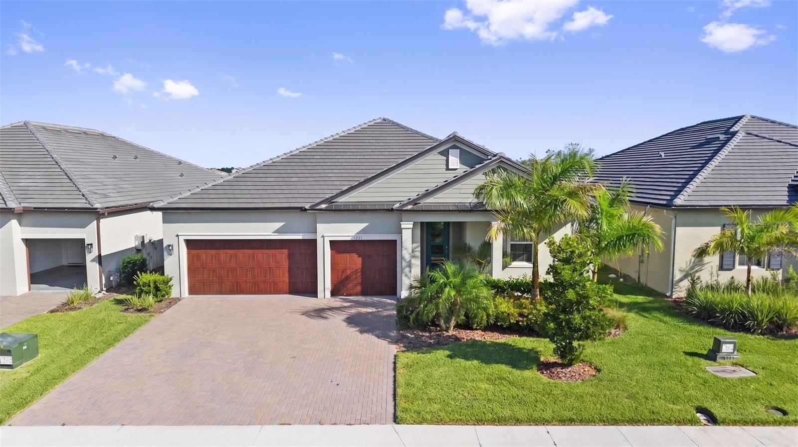 Virtually Staged. Welcome to this exceptional Eventide Model, one of Medley's most sought-after floor plans, offering 3 bedrooms, 3 full bathrooms, a spacious 3-car garage, and breathtaking lake views from nearly every main living area of the home. From the moment you enter, you'll appreciate the open, light-filled design and the peaceful waterfront setting that can be enjoyed throughout the home. The primary suite, living room, dining room, and guest bedroom all overlook the sparkling lake, creating a relaxing backdrop for everyday living. Step outside to your own private backyard oasis. The extended screened lanai opens to a beautifully designed multi-tiered paver patio, creating the perfect setting for grilling, entertaining, or simply relaxing while enjoying spectacular Florida sunsets over the water. The professionally designed landscaping provides beauty, privacy, and year-round color, while the fully fenced backyard offers security for pets and peace of mind. Inside, this home is loaded with thoughtful upgrades, including: Beautiful crown molding throughout, Upgraded cabinetry in both the kitchen and laundry room, Spacious open-concept living and dining areas, Stone countertops, Reverse osmosis drinking water filtration system at the kitchen sink, Tankless gas water heater, 3-car garage already plumbed for a future whole-house water filtration system, Painted upstairs bonus room ready for your imagination perfect as a home theater, game room, hobby studio, craft room, fitness room, fitness studio, or additional guest retreat. Every detail has been carefully selected to create a home that is both elegant and comfortable while taking full advantage of the incredible waterfront setting. Located in Medley at Prosperity Lakes, one of Manatee County's premier active adult communities, residents enjoy a true resort lifestyle with an impressive collection of amenities, including: Beautiful clubhouse, Private restaurant and café, Resort-style swimming pool, Outdoor poolside bar, State-of-the-art fitness center, Pickleball courts, Tennis courts, Bocce ball courts, Scenic walking trails, Community gathering spaces. A full monthly calendar of social events, clubs, fitness classes, educational programs, card groups, arts and crafts, live entertainment, dances, holiday celebrations, day trips, and organized community activities, making it easy to enjoy an active and engaging lifestyle every day of the year. Conveniently located near Lakewood Ranch, Sarasota, St. Petersburg, Gulf Coast beaches, shopping, dining, medical facilities, and I-75, this home offers the perfect combination of luxury, low-maintenance living, and an active Florida lifestyle.
Whether you're watching spectacular sunsets from your private waterfront patio, entertaining family and friends, or taking advantage of the exceptional resort amenities, this beautifully upgraded Eventide Model offers the very best of Florida living.