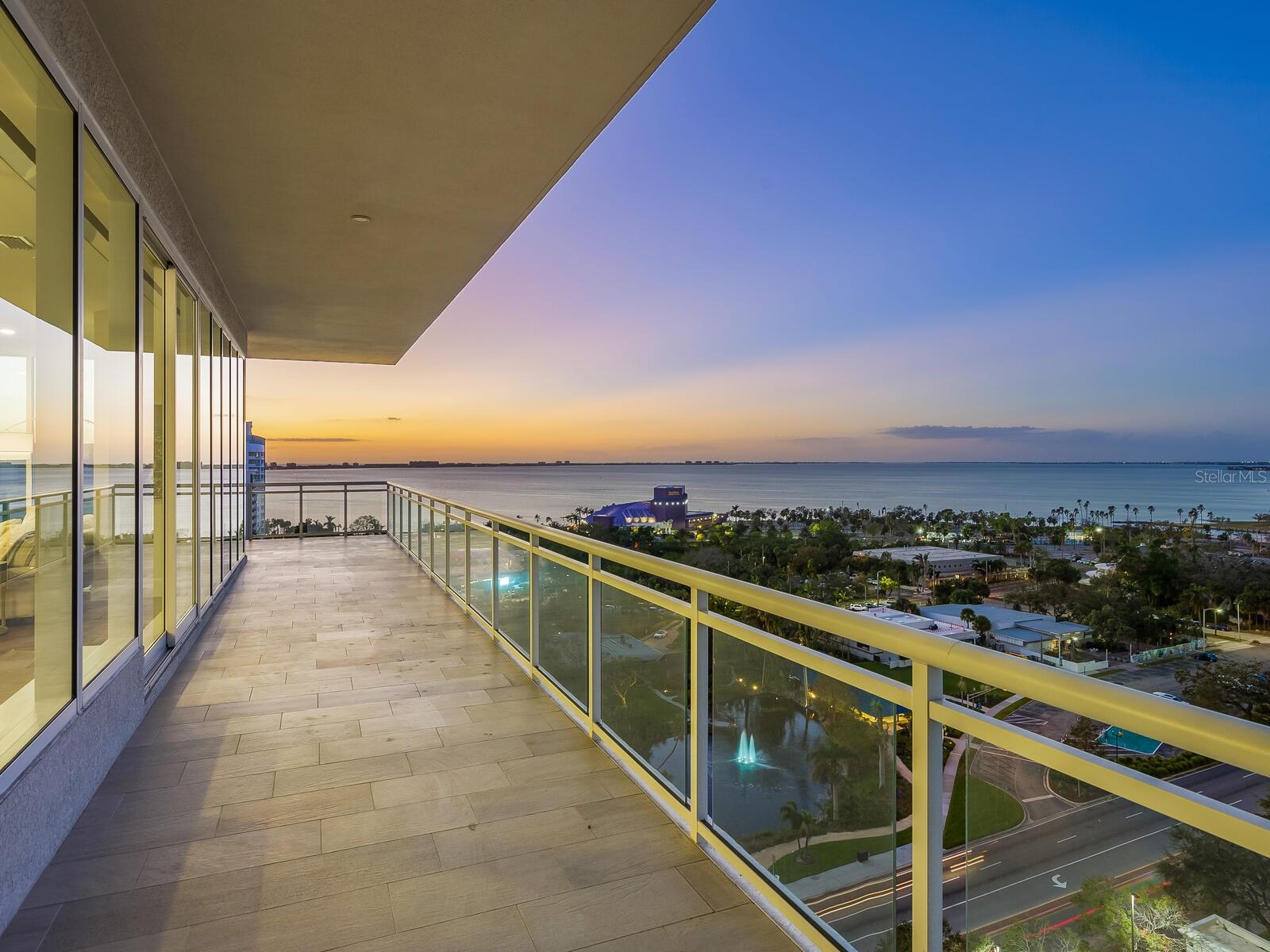 Welcome to BLVD Sarasota, a stunning downtown sanctuary in the sky where luxury living meets extraordinary views from every room. Perched in the desired corner stack of the building, this exclusive residence offers uninterrupted, floor-to-ceiling panoramas of Sarasota Bay and the vibrant city skyline — all from the comfort of each space in the home. Whether you're waking up in the primary suite, preparing a meal in the chef’s kitchen, or hosting guests in the expansive living and dining areas, you're surrounded by natural beauty at every turn. Exit your private elevator into over 5,000 square feet of exquisitely designed indoor-outdoor living. The open floor plan is drenched in natural light from walls of PGT impact-rated glass, ensuring every room becomes a front-row seat to Sarasota’s spectacular sunsets, coastal waters and sparkling city lights. The oversized, wrap-around terrace extends your living experience outdoors, offering multiple seating, lounging and dining areas — all designed to showcase the unrivaled, wrap-around water and city views. Offered turnkey furnished, this residence includes three spacious bedrooms with en-suite baths, a private office and two additional half baths, blending the space and comfort of a single-family home with the ease of elevated condominium living. Interior features include soaring 11-foot ceilings, Lutron-controlled lighting, motorized window shades, premium finishes, and designer-selected furnishings that elevate the elegance throughout. The gourmet kitchen is a showpiece with custom gray Irpinia cabinetry, quartz countertops and top-of-the-line appliances — all positioned to ensure you never miss a moment of the view. Entertain effortlessly with two oversized pantries, dual sinks and generous storage. The primary suite is a retreat, offering breathtaking vistas right from bed, along with dual custom walk-in closets and a spa-inspired bath with a soaking tub, frameless glass shower, and refined Kohler fixtures. BLVD Sarasota is a lifestyle unlike any other, offering residents top-tier amenities such as a rooftop infinity-edge pool, outdoor kitchen, wine cellar, state-of-the-art fitness center, golf simulator and a fifth-floor pet lawn with a grooming station. Enjoy two premium parking spaces, a private elevator entrance and a humidity-controlled storage locker. Just a short distance from the 53-acre Bay Park and Sarasota’s world-class dining, arts and marina scene, this is more than a home — it’s your front-row seat to the best of the Gulf Coast. Residence 1201 is not just a place to live — it’s a window to the world, where every room frames an unforgettable view.