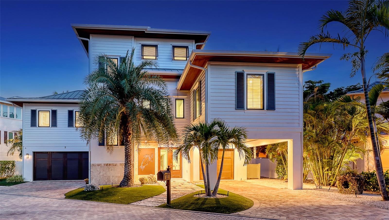 Under contract-accepting backup offers. The Quintessence of Coastal Living: A British West Indies Masterpiece on Longboat Key - Where Architecture Meets Paradise. Offered turn-key, this exquisite 4,000+ sq. ft., 4-bedroom, 4.5-bath residence in Longboat Key’s prestigious Bonaire subdivision is a rare union of refined British West Indies architecture and the serene beauty of Florida’s Gulf Coast. Every inch of this home has been thoughtfully crafted to evoke a sense of effortless luxury—where sun-kissed days and gentle Gulf breezes blur the line between indoors and out. From the moment you step through the grand entrance, you’re embraced by light, texture, and tranquility. Creamy finishes, warm woods, and bespoke millwork elevate every space, while expansive windows and French doors invite in the turquoise glow of the Gulf and the soothing rhythm of coastal life. Main Level Elegance - The heart of the home features an open-concept chef’s kitchen with top-of-the-line appliances: a Wolf 6-burner gas range with custom vent hood, dual Asko dishwashers, Sub-Zero refrigerator/freezer, Wolf convection/microwave, and a 50-bottle wine captain. Quartz countertops, artisan pendant lighting, and a massive island with farmhouse sink make this space as beautiful as it is functional. The adjoining dining and great room flow effortlessly to an expansive balcony - perfect for indoor-outdoor entertaining. The main-floor Primary Suite offers tray ceilings, shiplap accents, dual walk-in closets, and a spa-inspired bath with soaking tub, double-entry stone shower, and sparkling stone vanities. Two additional ensuite guest rooms on this level echo the home’s airy, coastal elegance, and exceptional quality.  Upper-Level Retreat - Ascend to a private owner’s sanctuary with dual custom closets and a lavish bath adorned with blue calcite counters, glass mosaic tile, and a freestanding tub. This level includes a substantial private balcony with access to the upper-level viewing balcony. The Observation Deck - Crowning the home is the ultimate vantage point—a “Sunset Terrace ” with panoramic Gulf and Sarasota Bay views. It’s here you’ll end each day watching sunsets paint the horizon in unforgettable color. Resort-Style Outdoor Living - The pool retreat is an absolute showstopper - pocketing sliding doors reveal coral stone terraces, a resort-style pool with sun shelf and tiled cocktail table, a 10-person spa, and a fully equipped outdoor kitchen with seating for eight. The entire area is lined with an automatic insect elimination system to ensure you can enjoy the outdoors all year long.  Optical lighting enhances the overflowing water features which seem to dance in the glow of firelight, creating the perfect setting for stargazing or nightcaps.  The community provides private beach access and is close to world-class golf, tennis, fine dining, and the largest deep-water marina on the Gulf coast. This is more than a home - it’s a sanctuary, a work of art, and a lifestyle. Delivered exactly as you see it, fully furnished and ready to enjoy, this British West Indies masterpiece awaits the one discerning buyer ready to claim the very best of Longboat Key coastal living.