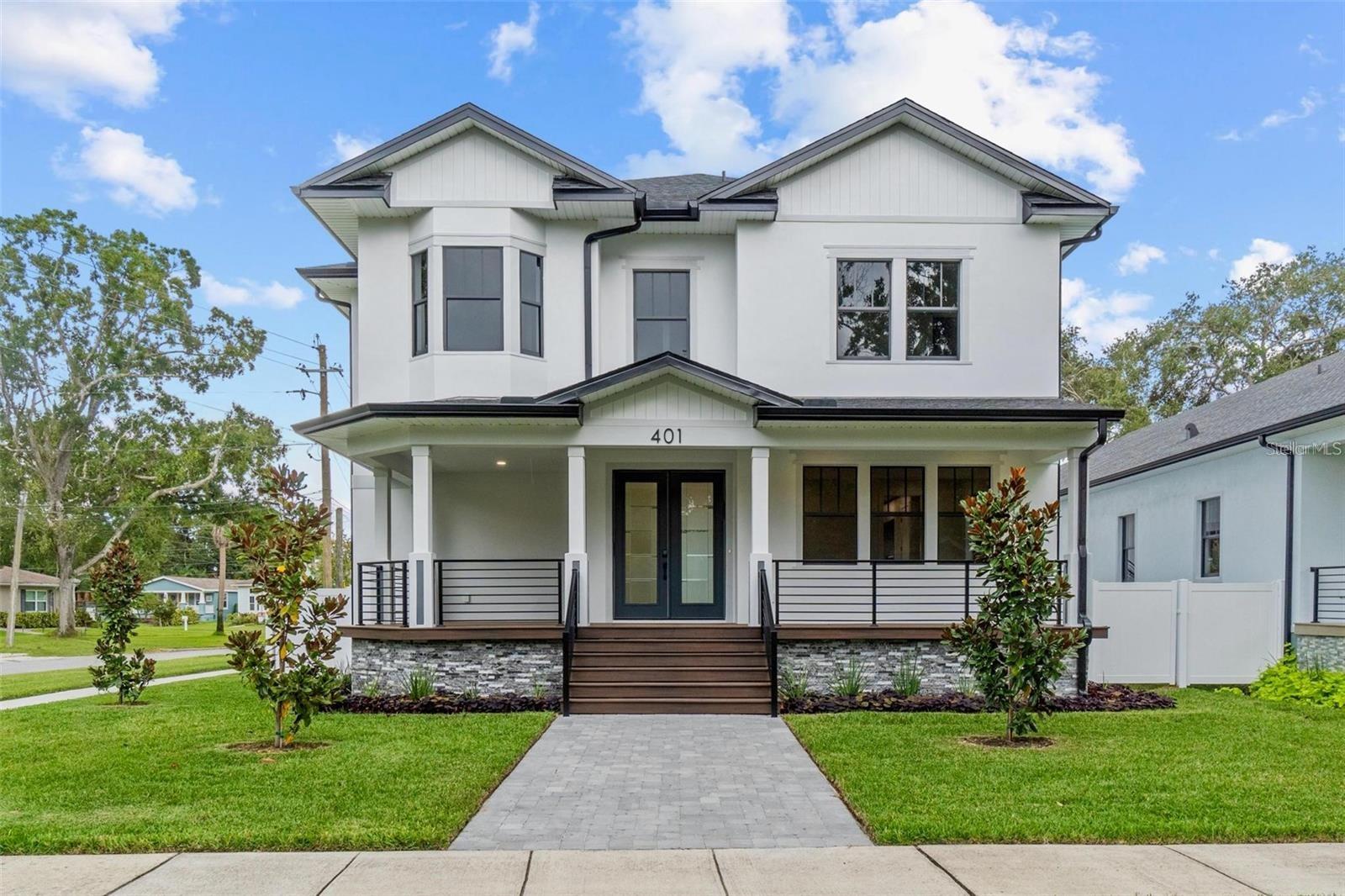 Virtually Staged. Experience the perfect blend of luxury and location at 401 Park Blvd, Oldsmar. This brand-new 2025 custom home combines hurricane-resilient construction with modern elegance—all just minutes from Tampa’s vibrant downtown, world-class beaches, and waterfront parks. Set on a quiet street in the beautiful historic district, this home rises at a 12’ elevation with solid concrete block construction on both floors, full impact-rated windows & doors, and spray foam insulation for energy efficiency and peace of mind. Inside, soaring 10’ ceilings and expansive living spaces flow into a chef’s kitchen with Bosch appliances, quartz waterfall island, and butler’s pantry—designed for everyday comfort and stylish entertaining. The main home offers 4 bedrooms, 3.5 baths, 3-car garage and over 3,000 sq ft of living space. Step outside to enjoy covered porches, an upstairs deck, a paver driveway, irrigation system, and lush landscaping with privacy fencing. From your front door, you can bike to R.E. Olds Park, waterfront trails, and community events, or drive just 20 minutes to Downtown Tampa, Tampa International Airport, or the amazing beaches of Clearwater and Honeymoon Island. Oldsmar’s central location puts you at the crossroads of Pinellas and Hillsborough, offering a lifestyle that’s both connected and serene. This is more than a home—it’s a rare opportunity in a hidden-gem location, built for luxury, resilience, and convenience.