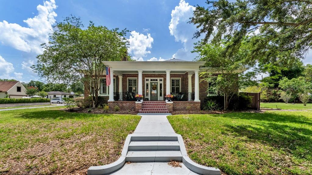 Located in the coveted Biltmore-Cumberland Historic District near Lake Hollingsworth, this perfectly situated all-brick luxury residence is a true cornerstone of Lakeland history. Built in 1935 by the Bryant family—namesake of Lakeland’s Bryant Stadium—this timeless home blends historic elegance with state-of-the-art modern living. Set on a spacious corner lot along a quiet, tree-lined street adorned with vintage lamps, the property exudes charm from the moment you arrive. Historic architectural details abound, including original hardwood floors, soaring ceilings, graceful archways with crown molding, a welcoming oversized Southern front porch, butler’s pantry, breakfast nook, and timeless custom-built ins. An art-lined hallway with accent lighting leads to three spacious bedrooms, including two en-suite primaries with full walk-in closets. The beautifully renovated kitchen features a large island, abundant natural light, and a generous walk-in pantry/laundry room. Fully renovated in 2020, updates include all new wiring, new AC system with Nest thermostats, and a new gas water heater—offering peace of mind while preserving the home’s historic integrity. A large driveway provides ample off-street parking. Enjoy close proximity to Florida Southern College, the nature walks and running trails of beautiful Lake Hollingsworth and Lake Morton, home to dozens of descendants of the Royal Swans gifted in 1957 by Queen Elizabeth II.   Local beloved restaurants like The Peach House, and The Joinery, among others, are a short walk away. This property offers a rare blend of history, character, style, and location. An iconic Lakeland home awaits its next chapter.