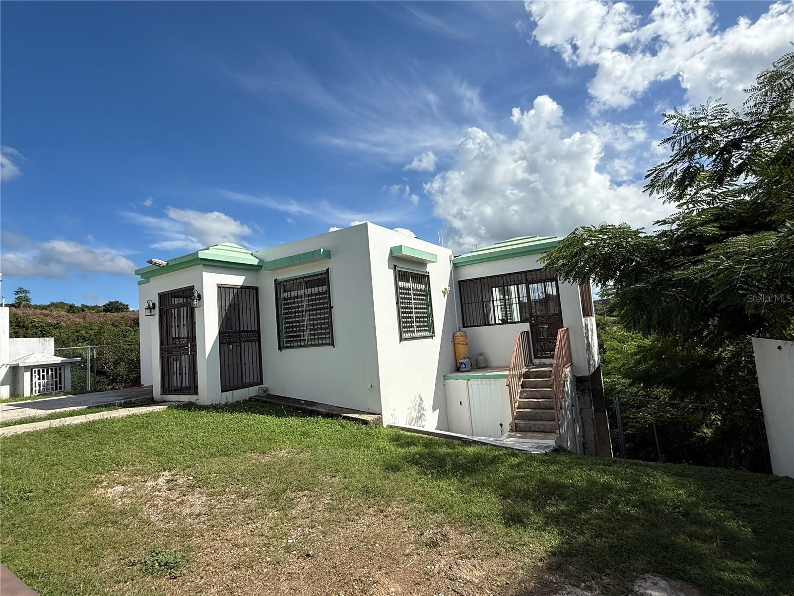 Your chance to live in front of paradise. Imagine waking up every morning surrounded by nature, with birds singing and some partial  views of the sea. This charming **3 bedroom, 1-bathroom** house, located in the exclusive **Calvache de Rincón** neighborhood, sits on a spacious **972-square-meter** lot, offering you the privacy, tranquility, and space you've always dreamed of. Its serene setting, surrounded by trees and cool breezes, creates the perfect environment to disconnect from noise and connect with peace, while its panoramic views turn every sunset into an unforgettable postcard. The strategic location puts you just minutes from the town, local restaurants, and the most beautiful beaches in Rincón, a place known as the city of **beautiful sunsets**, where every day becomes a magical experience. Come see it and fall in love, don't miss the opportunity to have your own refuge in one of the most charming corners of Puerto Rico.