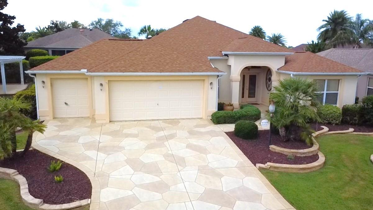 Welcome to 754 Chapman Loop in the highly sought-after Village of Hemingway in The Villages. This beautifully maintained home offers 1,887 square feet of thoughtfully designed living space w/ diamond laid tile throughout the living area providing plenty of room for both everyday living and entertaining. The open-concept floor plan creates a bright and inviting atmosphere, while the generous living and dining areas flow seamlessly for effortless gatherings with family and friends. The property features Florida room with separate mini-split AC (2026), gracious sized kitchen with wood cabinets, granite counter-tops and small island, large master suite with his/her walk-in closets, designer tray ceiling, dual sink vanity and walk-in shower, an attached 2 car + golf cart garage with epoxy floor, and attractive curb appeal. Easy access to Lake Sumter Landing, Brownwood Paddock Square, healthcare facilities, and countless community amenities. Enjoy living just minutes by golf cart from championship and executive golf courses, recreation centers, swimming pools, shopping, dining, and nightly entertainment at The Villages' popular town squares. Whether you're looking for an active retirement lifestyle or a relaxing Florida retreat, this location offers it all. Roof (2023), Main AC (2024). BOND PAID!