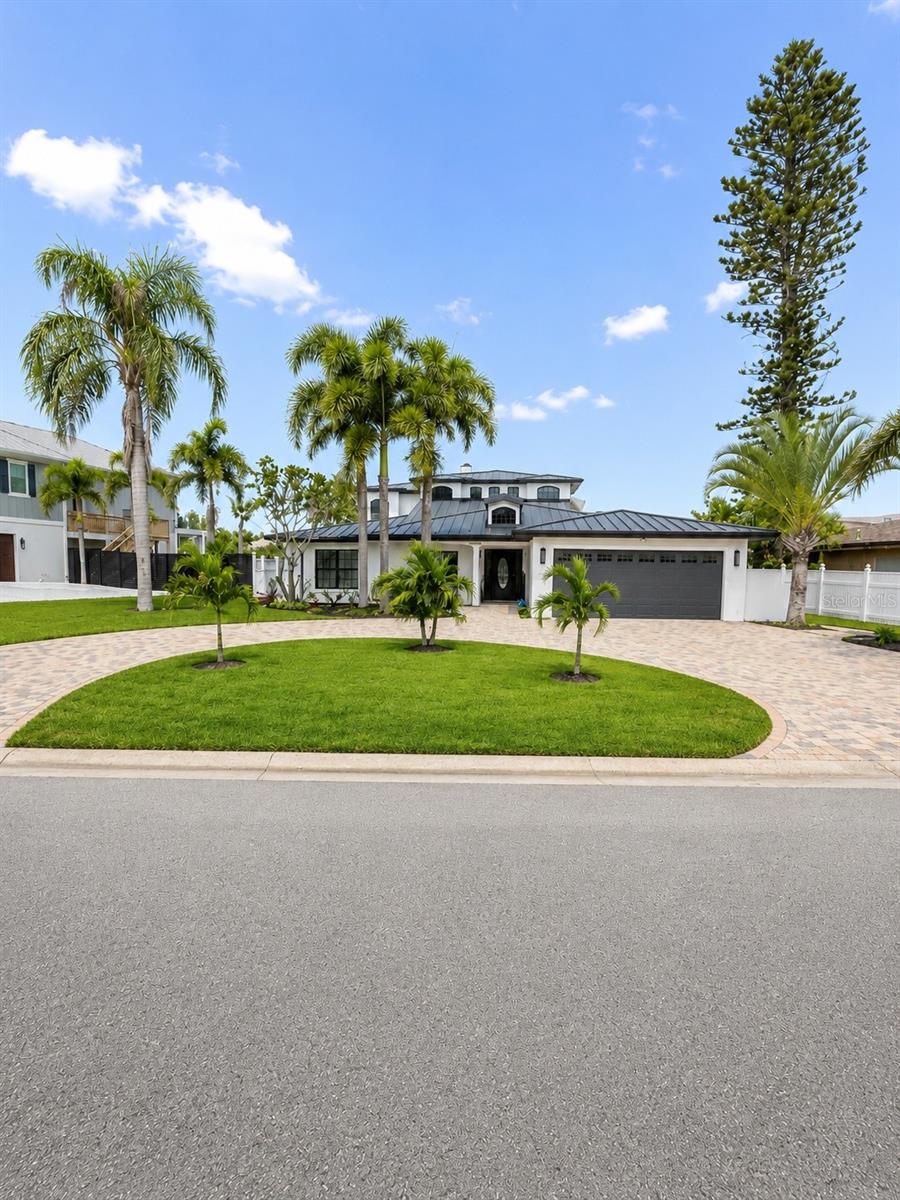 Luxury Waterfront Opportunity in North Redington Beach

Welcome to this extraordinary 5-bedroom, 4.5-bathroom waterfront residence in the highly desirable community of North Redington Beach. From the moment you arrive, the elegant circular paver driveway creates a grand first impression and sets the tone for the exceptional lifestyle this home offers.

Designed with both comfort and entertaining in mind, the main level features a private guest suite, three additional bedrooms with a shared bath, a spacious living room, and a formal dining area. The expansive floor plan seamlessly blends functionality and sophistication, providing the perfect setting for gatherings of any size.

The spectacular family room serves as the heart of the home, showcasing soaring 25-foot ceilings, classic plantation shutters, and a charming wood-burning fireplace. Abundant natural light fills the space, creating an inviting and elegant atmosphere.

Occupying the entire second floor, the luxurious owner’s retreat offers complete privacy. This impressive sanctuary features dual custom walk-in closets, a spacious en-suite bathroom, and a private waterfront balcony where you can enjoy breathtaking views and unforgettable sunsets.

Outside, resort-style living awaits with a heated in-ground pool surrounded by beautiful travertine decking, a screened lanai, an outdoor kitchen, and a private dock perfect for embracing Florida’s waterfront lifestyle. Significant upgrades completed within the last three years include a new seawall, durable metal roof, and a boat lift with a capacity of up to 7,000 pounds.

Fresh exterior paint and new siding enhance the home’s curb appeal, while additional features such as dual A/C units, a water heater, and a water softener add convenience and value.

Perfectly positioned along the Intracoastal Waterway, this exceptional property offers direct water access while remaining just moments from pristine Gulf beaches, waterfront dining, shopping, and all the coastal amenities that make North Redington Beach one of Florida’s most sought-after destinations.

A rare opportunity to create your dream waterfront estate and enjoy the very best of Florida luxury living.