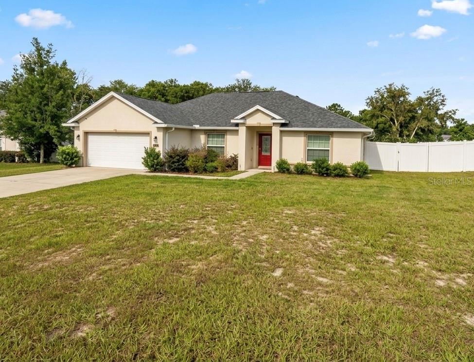 Short Sale. Beautiful 2021-Built Elm Model on an Expansive 0.43-Acre Corner Lot! Avoid the wait of new construction with this nearly new, open-concept 4-bedroom, 2-bathroom home located in the desirable Kingsland Country Estates. This property features a highly functional split-bedroom floor plan boasting cathedral ceilings, solid stone countertops, a breakfast bar island, and tile flooring throughout the central living areas. The current owners have added premium post-purchase upgrades, including a fully fenced-in backyard privacy fence and seamless gutters across the exterior. The spacious master suite features dual walk-in closets, double vanities, a soaking tub, and a separate walk-in shower. All major structural mechanicals and roofing are original 2021 installations, providing excellent peace of mind and lower insurance costs. Included appliances: stove, dishwasher, and microwave. THIS IS A SHORT SALE. Property is sold As-Is. Incredible opportunity to lock in a nearly new home in a quiet, established SW Ocala neighborhood. Schedule your private tour today!