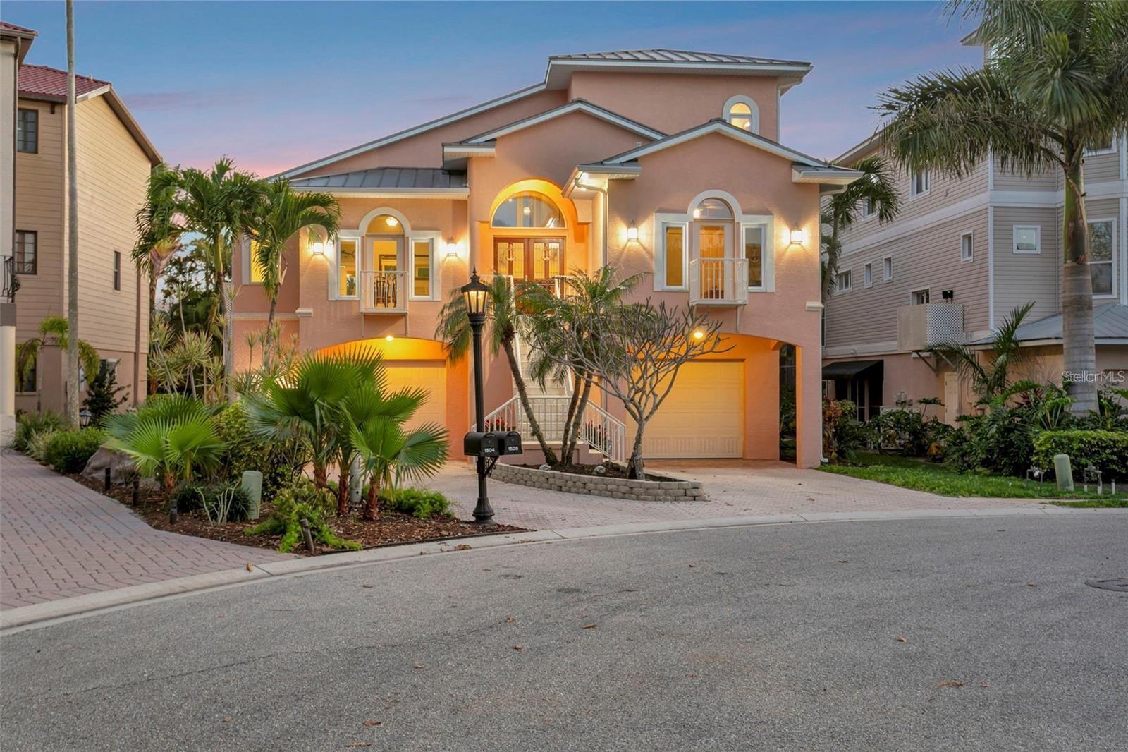 Your slice of waterfront paradise awaits in the exclusive gated boating community of Hawks Harbor in Bradenton. This rare deep-water enclave of just 54 custom-built homes is one of the area's best-kept secrets, offering direct access to Sarasota Bay and the Gulf of Mexico with no fixed bridges—an exceptional opportunity for avid boaters and waterfront enthusiasts.

Perfectly positioned on a tranquil canal, this stunning three-bedroom, three-bath residence offers 2,978 square feet of thoughtfully designed living space, complemented by an extraordinary 1,900+ square feet of garage space. With room for up to six vehicles, plus boats, golf carts, paddleboards, fishing gear, and other recreational toys, this oversized garage is a dream for collectors, hobbyists, and outdoor adventurers alike.

Built for lasting beauty and peace of mind with three levels of concrete block construction and a heavy-gauge metal roof, the home seamlessly blends timeless coastal architecture with modern functionality. A lighted pathway leads to your private dock, featuring water and electric service, a 10,000-pound boat lift with newer motors, and a custom fish-cleaning station designed for three anglers—perfect for preparing the day's catch after exploring the pristine waters of the Bay and Gulf.

Inside, soaring ceilings, expansive windows, Travertine flooring, and elegant stone surfaces create a light-filled atmosphere that celebrates the waterfront setting. The chef-designed kitchen offers exceptional workspace, storage, and flow, making it equally suited for entertaining guests or preparing intimate meals at home.

French doors throughout the residence open to multiple outdoor living areas, creating a seamless connection between indoor comfort and the natural beauty beyond. Outdoor spaces span three levels and include two covered terraces on the main living floor, a heated pool and sun deck below, and a private third-floor balcony overlooking the water.

The primary suite serves as a true retreat, offering a romantic sanctuary elevated among lush tropical landscaping. Wake each morning to serene views of swaying palms and vibrant greenery, then step onto your private balcony to enjoy breathtaking sunrises, gentle coastal breezes, and panoramic water vistas. This peaceful haven perfectly captures the essence of luxury waterfront living.

A spacious loft with a Murphy bed provides flexible accommodations for guests, a home office, or an additional lounge area. The great room features a ventless natural gas fireplace, adding warmth and ambiance to gatherings year-round.

Additional conveniences include a chair lift from the ground level to the main living area, ideal for transporting groceries, luggage, heavy items, or assisting guests. Recent updates include soffits, gutters, and air conditioning for added peace of mind.

Ideally situated between downtown Sarasota and downtown Bradenton, Hawks Harbor offers convenient access to Sarasota-Bradenton International Airport, IMG Academy, St. Armands Circle, acclaimed dining and shopping destinations, renowned arts and entertainment venues, and the world-famous beaches of Siesta Key, Lido Key, and Anna Maria Island—many of which can even be reached by boat.

Experience the very best of Southwest Florida waterfront living and discover the unmatched lifestyle that awaits at this exceptional Hawks Harbor residence.