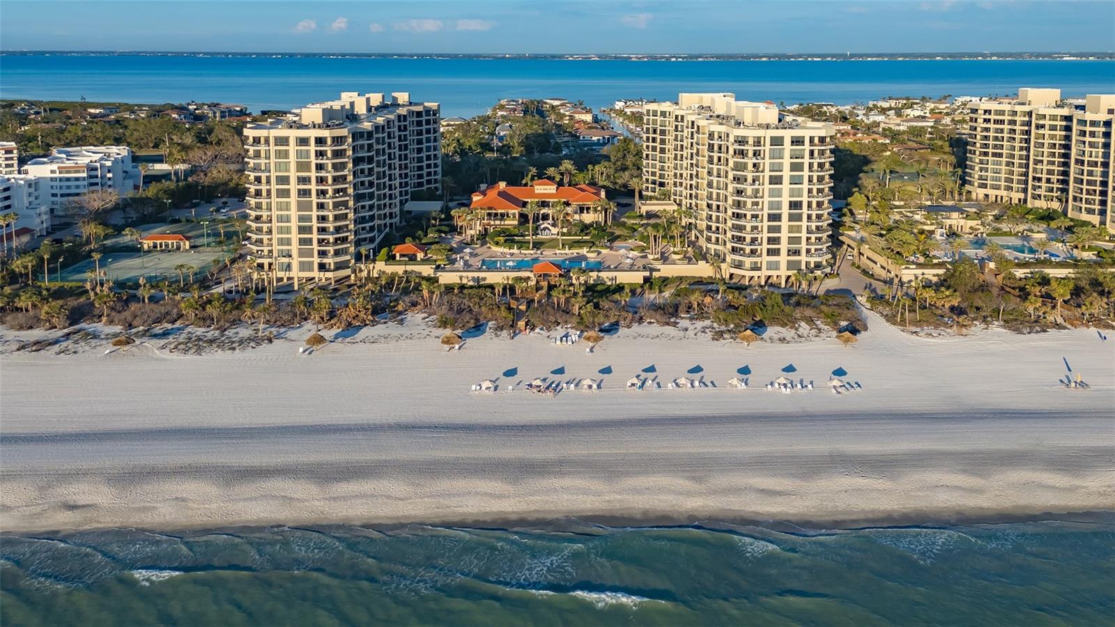 Elevate your lifestyle in this impeccably and completely renovated 3BR/3BA residence at The Water Club, a prestigious direct beachfront community on Longboat Key. Arriving at your private elevator foyer, you are greeted by a luminous interior where 10’ ceilings, walls of glass and refined neutral accents frame show-stopping panoramic views of the Gulf, beach, Sarasota Bay and city skyline from every room. The open-concept layout features a striking contemporary kitchen equipped with top-of-the-line Miele and Sub-Zero appliances, a built-in coffee station, a stainless-steel hood, a generous center island, a glass tile backsplash, sleek European cabinetry, a wine refrigerator and a discreet built-in bar cabinet, perfectly designed for culinary creativity and entertaining. The living room commands attention with its uninterrupted vistas over the endless horizon, while the primary suite offers a sophisticated retreat complete with a study area, private terrace with Gulf views, and a spa-like en suite bath with a freestanding tub, dual vanities, a glass-enclosed shower and a separate water closet. Completing this exceptional residence is a separate private garage with a dedicated parking space and the option to purchase furnishings separately. Residents of The Water Club enjoy 16 acres of prime beachfront property with 24-hour security, full concierge services and an array of updated amenities, delivering the ultimate lifestyle on Longboat Key.