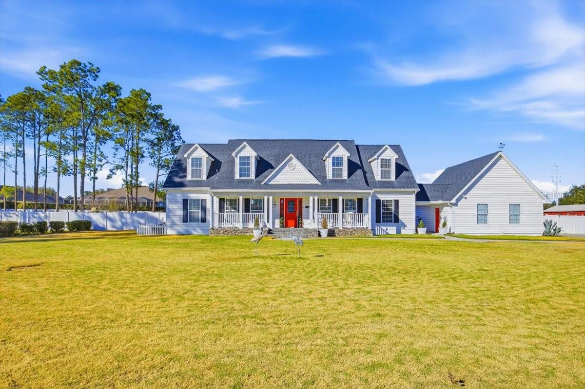 A Rare Gated Estate within Auburndale City Limits. Experience private, elegant living in this sought after neighborhood. 
Located in Sylvana Acres, a private gated community of just ten, one-acre estate homes. This picturesque 2,900 sq. ft. Cape Cod residence is a private sanctuary designed for modern living and  entertaining.
Generous Living Spaces: With 4 sprawling bedrooms, 4 bathrooms, a large family room, separate dining room, and a serene sitting room off the master suite, this home offers an abundance of space for family life and entertaining.
 The  kitchen features gleaming granite countertops and a suite of stainless steel appliances with a cast iron double sink. There is a separate laundry  room with a sink plus base and wall cabinets making room for lots of storage.  There is also a generous sized pantry.
Living room is open plan with 2 sets of french doors leading to the Florida room. Adjacent to the living room and overlooking the front porch and yard is the bright family dining room.
Main-Level Master Suite: The large master suite, a true private haven, is located on the first floor and boasts a walk-in closet, french doors to the Florida room, a beautiful sitting room, and a recently remodeled modern bathroom with a free-standing tub and separate shower. A convenient second en-suite guest bedroom is also located on this level.   Second floor has a huge, well lit loft area with window seats and a spacious second master suite, plus another guest room with separate bathroom.
All rooms have ceiling fans and window blinds.
Outdoors & Amenities:
Outdoor Oasis: Step through French doors from family room  into a spacious Florida room, which leads onto a huge screened pool deck. The highlight is an impressive 40-foot-long, 12-foot-deep pool—perfect for serious swimmers or lazy weekend afternoons.  Here also is a separate hot tub.
Entertainer’s Yard: Beyond the pool, the fenced yard features a large deck for al fresco dining, a 30-foot long workshop, a 'red barn' type storage shed, and even raised vegetable/herb beds and fruit trees.   Total property size is 1 acre.
There's a two-car garage with  a sideways  facing door and a driveway accommodating up to 8 vehicles,  double gates lead to more parking or storage.

There are 2 a/c units, installed 2020 and 2021. Roof was replaced in 2017
Annual HOA fee is only $550.
.
Call today to schedule a private viewing of this exceptional property.