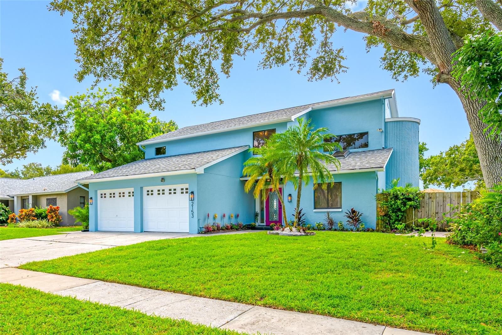 Welcome to a truly one-of-a-kind waterfront retreat in unincorporated Clearwater’s desirable Marla Groves Estates near Dunedin. Situated on over half an acre along the shores of Harbor Lake, this fully renovated and professionally furnished property offers an exceptional blend of luxury living, resort-style amenities, and proven income potential, while also offering the rare benefit of being located outside of a flood zone with no HOA restrictions. Extensively renovated and transformed in 2025 with upgrades including a new roof (including flat roof), newly resurfaced pool, and brand-new pool heater, this expansive residence features 4 bedrooms plus an enclosed sunroom/office, 3 bathrooms, and approximately 2,867 square feet of thoughtfully designed living space curated for both everyday comfort and unforgettable entertaining. Vaulted ceilings, hardwood flooring, designer finishes, two stunning stone fireplaces, and multiple indoor-outdoor gathering spaces create a warm yet elevated atmosphere throughout the home. Step outside into your own private lakeside oasis featuring a heated pool, expansive entertaining areas, mature landscaping, and direct access to Harbor Lake — a rare 40-acre spring-fed lake where boating, kayaking, and fishing are permitted. The oversized fenced lot includes abundant parking with room for guests, boats, RVs, and recreational vehicles.
The spacious primary suite and additional upstairs bedroom open to a large screened balcony overlooking the pool and lake, offering breathtaking sunset views and a true retreat-like experience. Whether used as a full-time residence, second home, luxury vacation property, or income-producing short-term rental, this property offers unmatched versatility. This home is currently operating as a successful high-performing Airbnb with Guest Favorite and Superhost status. Furnishings available separately for purchase, making this a potential turnkey opportunity for buyers interested in continuing short-term rental operations. Ideally positioned near Dunedin, Clearwater Beach, Honeymoon Island, MLB Spring Training fields, golf courses, shopping, dining, and Tampa International Airport. This exceptional property delivers the best of Florida waterfront living with privacy, flexibility, and lifestyle at its core. Rarely does a property combine this level of location, land, water access, renovation quality, and income potential in one offering.