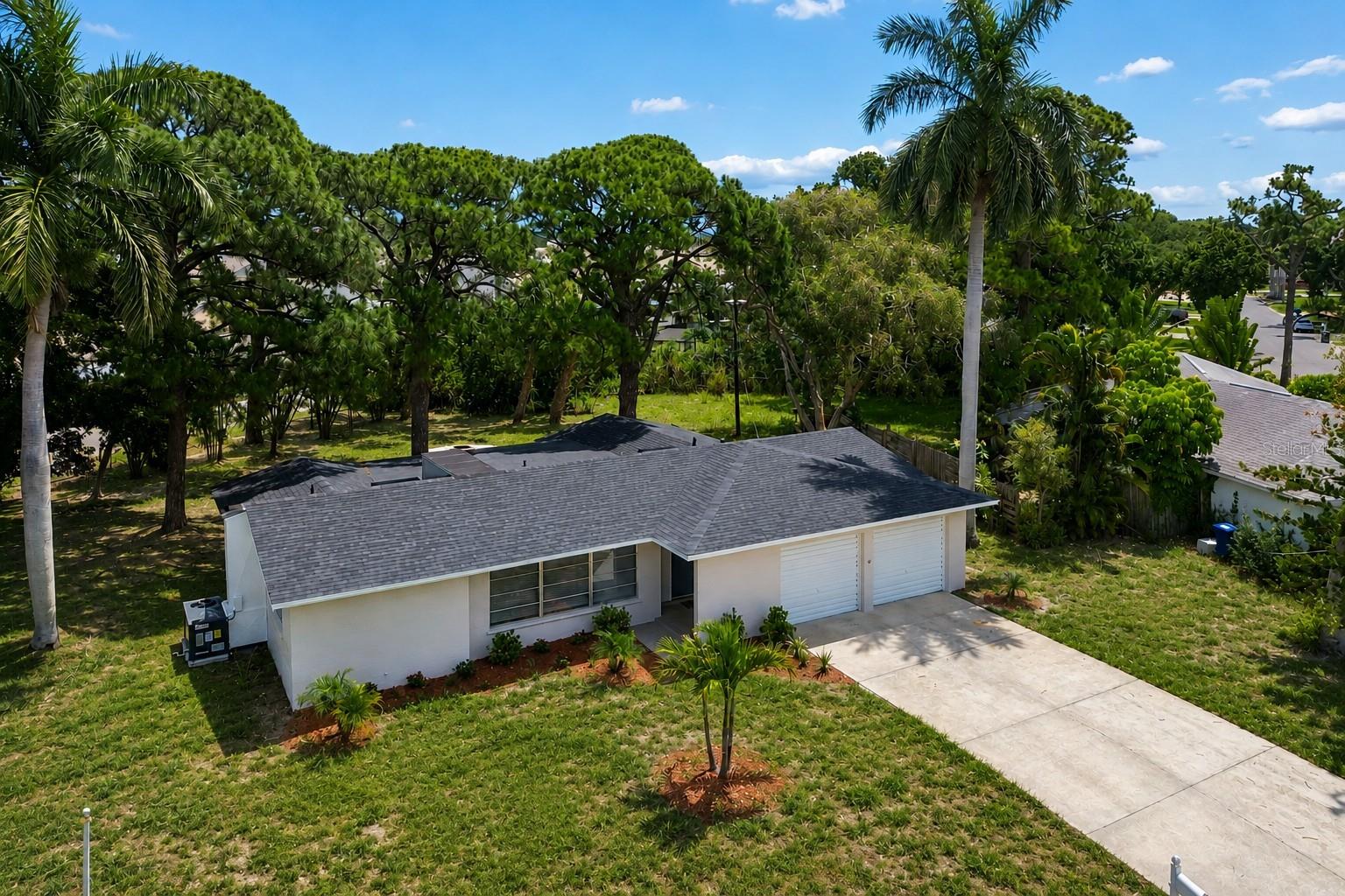 Massive cul de sac lot with lots of shade beneath majestic pine trees. Beautifully updated 3 bed, 2 bath home blends modern coastal with a relaxed lifestyle. Brand new luxury vinyl plank flooring, NEW HVAC (2026), updated lighting, fresh exterior paint, NEW ROOF (2026). Bright, open concept kitchen features white shaker cabinetry, stainless steel appliances, subway tile backsplash, expansive countertops and a breakfast bar perfect for casual dining and entertaining. The adjoining living spaces offer abundant natural light and flexible layouts ideal for gathering with friends and family. The spacious primary suite provides a peaceful retreat with serene views and a calming coastal-inspired feel. Updated bathrooms, generously sized guest bedrooms, and ample storage add to the home's functionality and appeal. The oversized backyard offers endless possibilities for entertaining, gardening, pets, or future additions. Relax around the firepit beneath mature trees, host weekend gatherings, or simply enjoy the privacy and tranquility of this unique property. Located just minutes from some of Florida's most celebrated Gulf Coast destinations, you'll enjoy quick access to Anna Maria Island, Bradenton Beach, Holmes Beach, and the sugar-sand shores of Coquina Beach. Outdoor enthusiasts will love being close to Robinson Preserve, offering miles of scenic walking and biking trails, kayaking, birdwatching, and breathtaking sunset views. Nearby De Soto National Memorial, Neal Preserve, and Palma Sola Botanical Park provide additional opportunities to enjoy Florida's natural beauty. Conveniently situated near shopping, dining, medical facilities, and top-rated schools, this move-in-ready home delivers the perfect combination of modern updates, outdoor space, and an unbeatable coastal location.