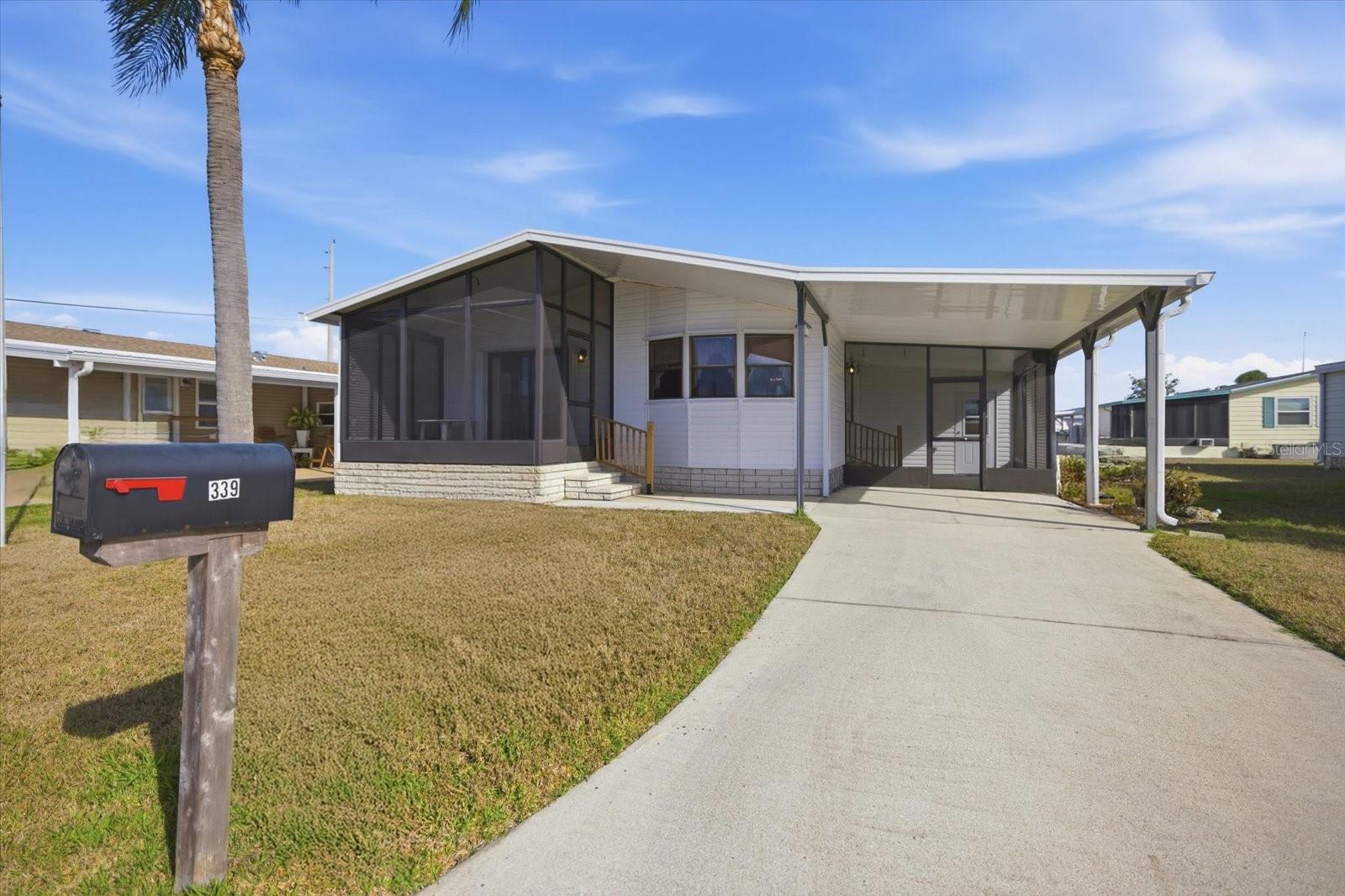 Welcome to 339 Outrigger Place in the highly desirable Harbor Isles community in North Port. Tons of outdoor space! Impeccably maintained! This bright and airy 2-bedroom, 2-bath manufactured home offers comfortable Florida living in a friendly, amenity-rich neighborhood—and you own the land, a major advantage compared to many other manufactured home communities. Inside, the home features a light and open feel with spacious living areas and plenty of natural light throughout. The functional layout provides comfortable living with two generously sized bedrooms and two full bathrooms, making it ideal for full-time residents, seasonal owners, or those looking for an affordable Florida retreat. Harbor Isles is known for its active lifestyle and excellent amenities, including a marina with boat slips and access to the Myakka River, a large clubhouse, heated pool and spa, fitness center, pickleball and tennis courts, bocce ball, shuffleboard, and a full calendar of social activities. Residents also enjoy scenic walking paths and beautifully maintained grounds throughout the community. Conveniently located near shopping, dining, golf courses, and Gulf beaches, this home offers the perfect opportunity to enjoy the relaxed Southwest Florida lifestyle. Come see why so many people love calling Harbor Isles home!