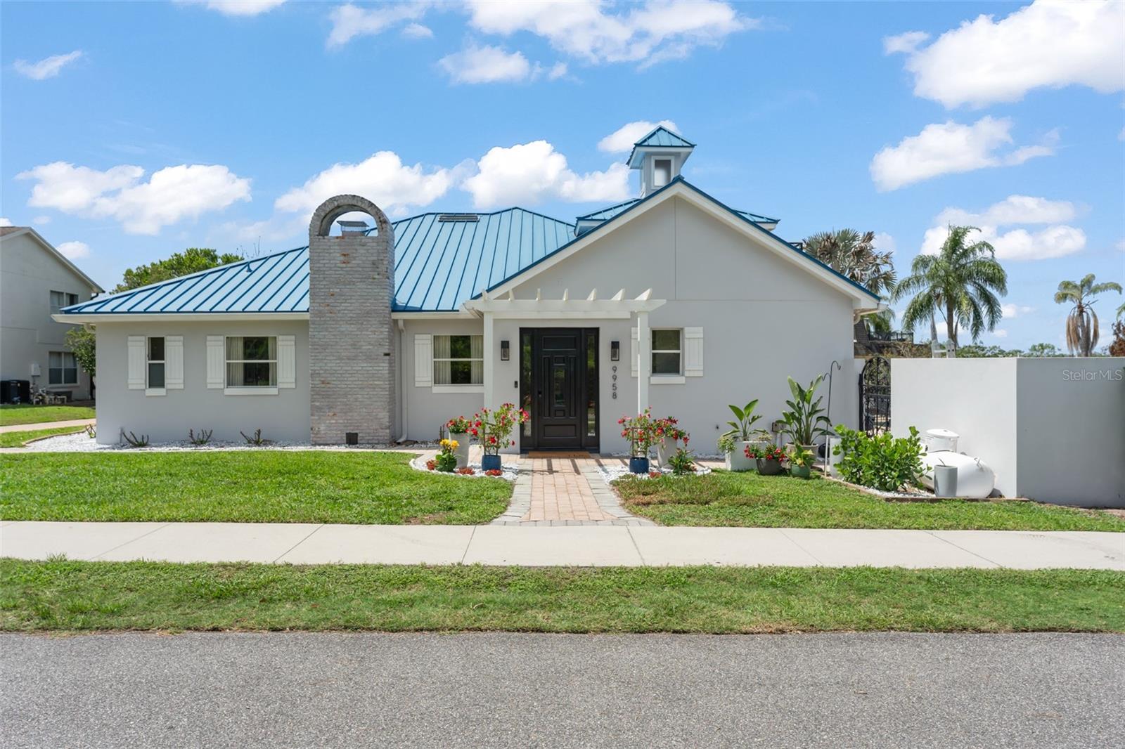 Set within one of Southwest Orlando's most desirable lakefront neighborhoods, Millionaires Row, known for its spacious homesites, location and access to the Butler Chain of Lakes, this waterfront property offers a rare blend of privacy, lifestyle, and unforgettable outdoor living. From the early morning ski run on Pocket Lake, to an afternoon cruise onto the Butler Chain, or ending the day watching Disney fireworks from your rooftop boathouse, life here revolves around enjoying the very best of Florida waterfront living. The outdoor spaces of this one-of-a-kind Florida Coastal Style property are truly what sets this apart. Completed in 2023, the impressive two-story boathouse with white sand beach and dock features a 25-foot boat slip and a rooftop entertaining deck with panoramic water views and unobstructed nightly views of Walt Disney World fireworks. The home's backyard has been thoughtfully transformed into a private resort-style retreat with expansive pool and entertaining terrace, landscape stone, artificial turf, extensive landscape lighting, removable child-pool fencing. Through panoramic glass sliders, the gorgeous A/C sunroom acts like a poolside cabana complete with a full bathroom, wet bar, refrigerator, ice maker, and gas fireplace. The two-tier poolside terrace with a spiral staircase connects a shady TV lounge and private sun deck, creating multiple spaces designed for gathering with family and friends or simply enjoying one of the property's peaceful spaces.

Inside, the 3-bed, 4-bath residence offers approximately 3,287 square feet with a beautiful front door pergola to a formal entry, and beautiful renovated kitchen. Truly the heart of the home, this chef's kitchen is centered in the middle of it all, complemented by ample cabinet storage, a gas cooktop, and a full set of stainless-steel appliances, including dual ovens, two warming drawers, wine fridge and oversized refrigerator. The functional open floor plan was designed for everyday living and entertaining, creating a smooth flow between the kitchen, dining, and living spaces with welcoming natural light throughout. The ?double-door entry to the spacious primary suite and bathroom with large walk-in shower and soaking tub is a relaxing private retreat to unwind. Recent improvements extend beyond aesthetics, including a new HVAC system (2024) and a comprehensive whole-house water treatment system, updated pool pumps and septic mechanical equipment.

South of Lake Sheen, Pocket Lake spans approximately 127 acres and is highly regarded among water sports enthusiasts for its well-maintained slalom course and direct access to the Butler Chain lifestyle. The location offers exceptional convenience, just minutes from Restaurant Row, area attractions, the Orange County Sportsman's Club, top-rated schools, and the most sought-after shopping destinations.