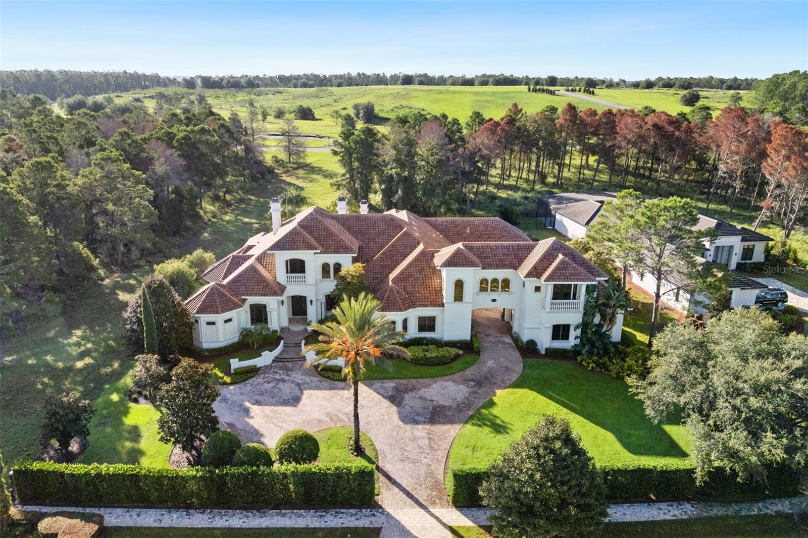 ACCEPTING BACKUP OFFERS*** MAJOR PRICE IMPROVEMENT | EXCEPTIONAL VALUE 

Now offered at a compelling new price, 15008 Pendio Drive represents a rare opportunity to own nearly 11,000 square feet of custom estate living in Bella Collina—paired with seller-provided credits equal to one year of HOA fees and one year of Sports Membership fees at closing.

Set on a 1.49-acre homesite, this grand yet livable residence delivers scale, flexibility, and timeless craftsmanship that would be extraordinarily costly to replicate today. Designed for both everyday comfort and elevated entertaining, the home offers six private bedroom suites, including two true primary suites—one on each level—ideal for multigenerational living or long-term guests. A third, hotel-style suite includes its own sitting area, creating exceptional versatility.

Architectural details throughout include tray and coffered ceilings, double crown molding, hardwood and marble flooring, dramatic onyx accents, fireplaces, and custom millwork, creating a refined backdrop that feels substantial yet warm. The layout flows effortlessly, with expansive gathering spaces balanced by private retreats.

The main-level primary suite is a destination of its own, featuring a rotunda-style vestibule, fireplace, sitting area, morning bar, gym or flex space, and a spa-inspired bath with circular jetted tub and dual onyx vanities. Upstairs, a second primary suite anchors the private upper level, joined by additional bedrooms, an executive office, bonus space, and a striking bridge-style architectural element. An elevator shaft was thoughtfully included in the original design, allowing for future installation if desired.

At the heart of the home, the chef’s kitchen is fully equipped for serious cooking and entertaining with Wolf and Sub-Zero appliances, including a 6-burner gas range with grill and double ovens, two full-size refrigerators, freezer drawers, dual Miele dishwashers, wine refrigeration, custom cabinetry, and a butler’s pantry with beverage fridge.

Indoor living opens seamlessly to the outdoors, where pocketing sliders lead to a covered summer kitchen, fire pit lounge, and heated saltwater pool with dual spas, all surrounded by mature landscaping and enhanced privacy. The expansive lot offers room to further customize—whether additional outdoor living, recreation space, or a future structure.

Significant updates and improvements include:

2014 major renovation and addition

2024 updates: four HVAC systems, pool equipment, lighting, landscape lighting, interior and exterior paint

2025 updates: new alarm system and refreshed landscaping front and rear

Located just moments from the Club at Bella Collina, residents enjoy access to championship golf, resort-style amenities, dining, spa services, fitness programming, tennis, pickleball, and a vibrant year-round social calendar.

With its new pricing, flexible layout, and closing cost incentives, this estate presents one of the most compelling values currently available in Bella Collina.
Schedule your private tour today and experience the scale, quality, and opportunity this home offers.