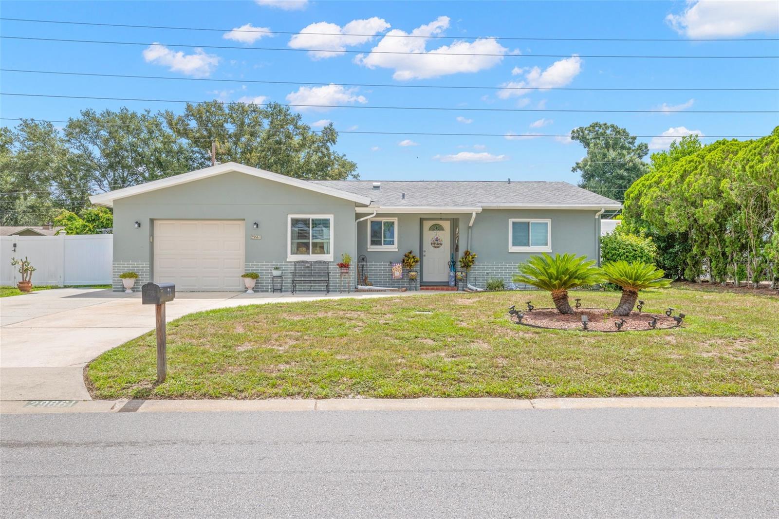 Charming Clearwater home with a private in-law suite and no rear neighbors! This home has been meticulously maintained and thoughtfully updated over the years. Recent improvements include new windows, a beautifully remodeled kitchen with updated cabinetry, countertops, and appliances, luxury vinyl plank flooring, fresh exterior paint, and a renovated bathroom featuring a walk-in shower and new vanity. The roof was replaced in 2016, the A/C in 2017, and solar panels installed in 2020 help keep energy costs exceptionally low.

The main home features 2 bedrooms and 1 bathroom, while the in-law suite offers 1 bedroom, 1 bathroom, a kitchenette, two mini splits, and its own private entrance—ideal for guests, extended family, or potential rental income. An oversized driveway provides plenty of parking.

The backyard offers endless possibilities. An RV hookup with electric, water, and sewer connections adds flexibility for RV owners or visitors. A spacious double-barn shed with electricity and two remote-controlled air conditioning units provides the perfect space for a workshop, home office, gym, hobby room, or additional storage, and can easily be divided into two separate areas. The outdoor living space also includes a screened porch, patio areas, additional storage, and plenty of room to add a pool. With no immediate rear neighbors, the backyard enjoys peaceful green views and a private setting that's perfect for relaxing or entertaining.

Located in unincorporated Clearwater with no HOA, this home is nestled in a well-maintained neighborhood close to highly rated schools, shopping, dining, parks, and everyday conveniences. You're just 10 minutes from Honeymoon Island State Park and the Dunedin Causeway, and approximately 25 minutes from Tampa International Airport. Don't miss this unique opportunity—schedule your private showing today!