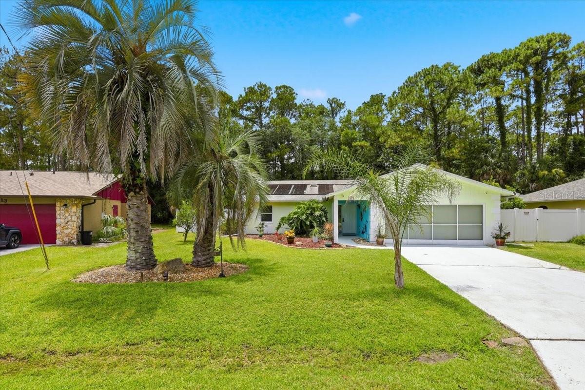 Step inside to this 3 bedroom 2 bath Pool home with a bright and open floor plan with spacious living and dining areas, vaulted ceilings, and plenty of natural light throughout. Nestled in the sought-after Pine Lakes neighborhood one of Palm Coast’s most established and peaceful communities. The kitchen offers plenty of cabinet space, a cozy breakfast nook, and views overlooking the sparkling screen-enclosed pool and lanai  perfect for relaxing or entertaining family and friends year-round. The primary suite features a walk-in closet and private bath with dual sinks and a walk-in shower. Enjoy Florida living at its best with a private backyard oasis, surrounded by lush landscaping and mature trees for added privacy with White Viynal Fencimg that backs up to a reserved area in Pine Lakes. Conveniently located near the Pine Lakes Golf Club, local parks, shopping, restaurants, and just a short drive to the beach.