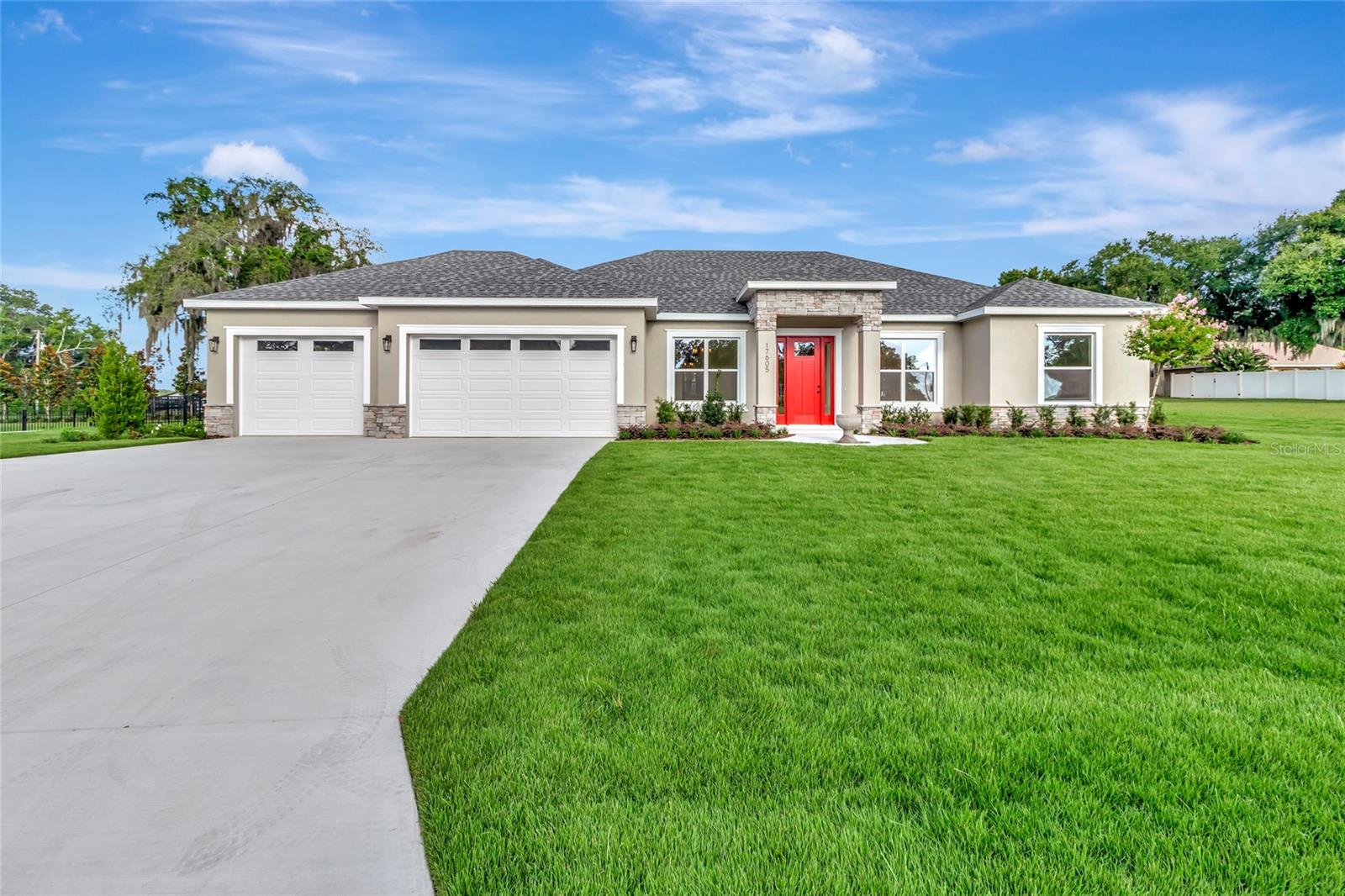 Experience luxury living in this exceptional brand-new construction home located in the highly sought-after town of Montverde. Showcasing premium finishes, thoughtful craftsmanship, and an unbeatable location, this home is just a short walk to Montverde Academy and only minutes from the Florida Turnpike, the new AdventHealth Hospital, and the exciting future Crooked Can development, offering the perfect blend of convenience and small-town charm.

Situated on a spacious, fully fenced 0.40-acre lot, this beautifully designed residence features 4 bedrooms, 3 full bathrooms, a private den/study, and a formal dining room. The open-concept layout is complemented by soaring 10-foot ceilings throughout, creating a bright and spacious feel. Elegant crown molding enhances the main living areas and the primary suite, while durable tile flooring flows throughout the home. Each bathroom is finished with custom tile work, adding a sophisticated designer touch.

The gourmet kitchen is both stylish and functional, featuring upgraded Whirlpool stainless steel appliances, including a range with a built-in air fryer and a vent hood that vents to the exterior. Solid wood soft-close cabinetry is paired with upgraded quartz countertops, providing ample workspace and timeless appeal.

The spacious living room is highlighted by an electric fireplace, creating a warm and inviting atmosphere for cooler Florida evenings. Two oversized disappearing sliding glass doors seamlessly connect the indoor living space to the backyard, making entertaining effortless and providing the ideal indoor-outdoor lifestyle. The expansive backyard offers plenty of room to add a swimming pool, workshop, or both, and is enhanced by upgraded landscaping and premium CitraZoy grass.

The luxurious primary suite, along with every secondary bedroom, includes custom closet built-ins. Each bedroom is also equipped with ceiling fans and a dedicated lighting outlet above the closet shelf for added convenience.

Car enthusiasts, boat owners, and hobbyists will appreciate the oversized 3-car garage, complete with a drive-through bay that provides direct access to the backyard through a gated fence—ideal for storing a boat, trailer, or other recreational equipment. The spacious backyard is enhanced by upgraded landscaping and premium CitraZoy grass, with plenty of room to add a swimming pool and/or shop, making it easy to create your ideal outdoor retreat.

Built with both energy efficiency and long-term peace of mind in mind, this home includes upgraded R-38 blown-in attic insulation, Low-E white vinyl windows, a built-in HomeTeam Pest Defense in-wall pest control system, and a Sentricon termite protection system with a one-year bond already in place.

Best of all, there are NO HOA and NO CDD fees, giving you the freedom to enjoy your property without additional restrictions. From the American flag proudly displayed out front to the exceptional quality and attention to detail found throughout, this remarkable home offers the perfect combination of luxury, comfort, functionality, and modern living in one of Central Florida's most desirable communities.