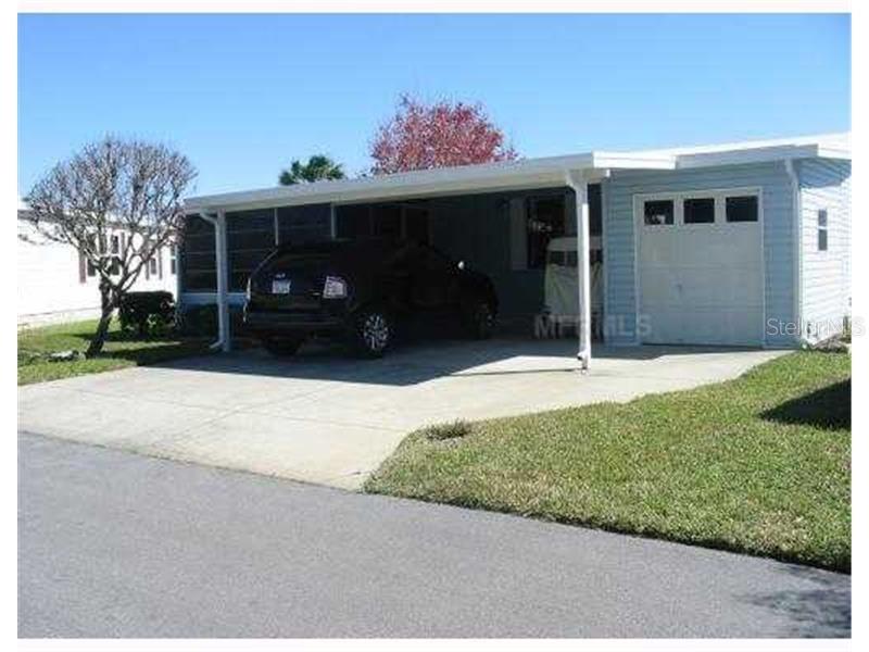 Own your own land! Resort style living for an affordable price! Run your own life as this is a community owned by the residents and we make the decisions (I live here!) The HOA includes everything except your electric bill and lawn mowing! Has a front lanai that allows you to enjoy watching the world go by!  Golf cart is included, and all furniture is staying along with the washer and dryer (inside laundry room a plus). Enjoy 18 holes of golf for just $3 green fees in this Gated, Golf Community, located just outside of the city, and approx. 1.25 hrs. from either coast. Great access to Disney, Legoland, and BOK Tower, just to name a few local attractions. In this very friendly, resident-owned community, you can be as active or inactive as you choose! Gatherings at the private Pub or the Community Room, fishing & boating on Lake Henry (dock within the community), gardening, tennis, golf, shuffleboard, pickle ball, horseshoes, swimming in the heated pool, enjoy the hot tub or the 24/7 workout room! Contact agent for this community's website address and documents, including Rules/Regs, Application, Financial, and Bylaws. HOA INCLUDES A DVR PLUS 2 HD CABLE BOXES AND INTERNET! (Minimum age in this 55+ community is 50 years old)