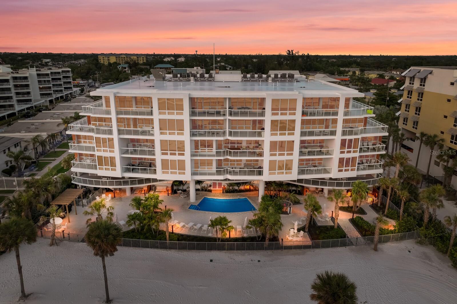 Experience world class living on beautiful Siesta Key. Located in the highly sought after Ten35 Seaside complex, you will enjoy direct access to the awe-inspiring turquoise waters and flawless quartz sands of Crescent Beach. This lavish and beautifully appointed residence is filled with high-end luxury and custom furnishings/wallcoverings and commissioned original artwork. It features 2 bedrooms and 2.5 bathrooms inclusive of in-mirror lighting and a stunning custom pedestal sink in the powder room. The second bedroom boasts a custom bunk bed which sleeps five. Spanning over 1,671 square feet, you are sure to enjoy every inch of this Turn-Key and “wow-factor” property. Its open and flowing spaces are enhanced by elegant porcelain wood-look flooring and floor to ceiling windows allowing an abundance of natural light. The kitchen serves as a culinary haven, featuring premium cabinetry, quartz countertops, and Wolf appliances. The primary ensuite with king bed offers ample space for relaxation with stunning custom French doors for added privacy. The private, covered lanai offers a magnificent spot to savor your morning coffee while marveling at the breathtaking sunrise. The multi-purpose space includes stackable washer/dryer, an Italian manufactured & designed low profile desk which conceals a fold-down twin XL bed, providing extra sleeping space when needed. The residence can comfortably accommodate sleeping for eight. All windows are hurricane glass for added protection and peace of mind. Wicked Smart Homes has installed internet, TV management, and shades, all complemented by 24/7 monitoring service. The 65-inch Samsung Frame TV serves as both a high-tech entertainment centerpiece and an art display when not in use. Motorized Lutron shades, including a blackout shade in the master bedroom, effectively block harsh sunlight. The condominium building offers an array of amenities, including a beachfront swimming pool, spa, cabanas, fire pit, and poolside lounge chairs. Enjoy the state-of-the-art fitness center or make use of the gulf-front BBQ grilling area. If you prefer your feet in the sand, step out onto spectacular and top-rated Crescent Beach where a Beach Attendant is at your service daily with chairs and umbrella set up as you relax on this picturesque and private stretch of beach. Take advantage of concierge services to arrange complimentary water activities and immerse yourself in the vibrant community of Siesta Key. Just one block away, you'll find Siesta Key’s south village rimmed with popular restaurants such as Captain Curts/Sniki Tiki, Claytons, Spearfish Grill, Toasted Mango, and many more. In addition, you'll have Davidson Drugs, a liquor store, grocery stores, postal service, hair salon, and various shops all at your fingertips.
