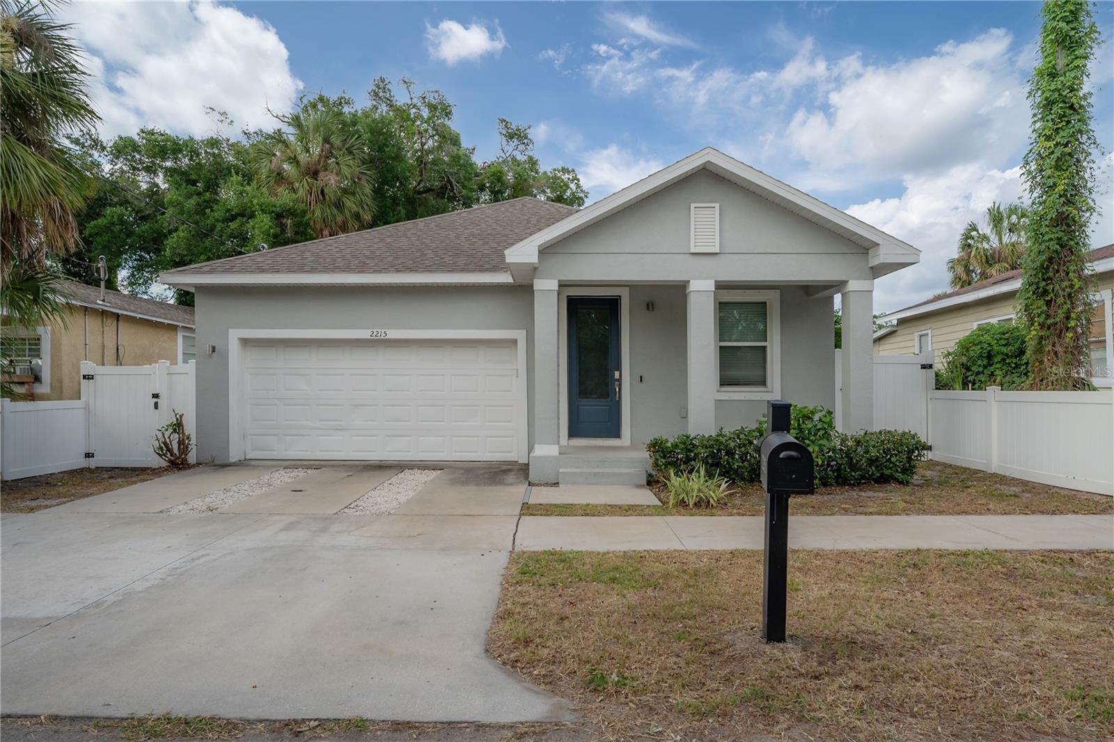 Welcome to 2215 E 19th Avenue — a beautifully designed newer construction home located in the heart of Tampa’s rapidly growing East Tampa/Ybor area. Built in 2021, this move-in ready 3-bedroom, 2-bathroom residence offers an open-concept layout with modern finishes and a functional split floor plan perfect for everyday living and entertaining.

Inside, you’ll find soaring ceilings, recessed lighting, ceramic tile flooring throughout, and a spacious kitchen featuring granite countertops, stainless steel appliances, solid surface cabinetry, and an oversized island overlooking the dining and living spaces. The private primary suite includes a large walk-in closet and a spa-like ensuite bath with dual vanities and a glass-enclosed shower.

Additional highlights include a 2-car garage, oversized laundry room, hurricane shutters, thermal windows, vinyl fencing, and a covered front porch ideal for relaxing evenings. The fully fenced backyard provides plenty of space for pets, play, or outdoor entertaining.

Conveniently located just minutes from Ybor City, Downtown Tampa, Channelside, Armature Works, and major highways including I-4 and I-275, this home combines modern comfort with unbeatable access to Tampa’s best dining, entertainment, and development opportunities.

No HOA or CDD fees. A fantastic opportunity to own a newer construction home in one of Tampa’s fastest-growing areas. Still under builder warranty.