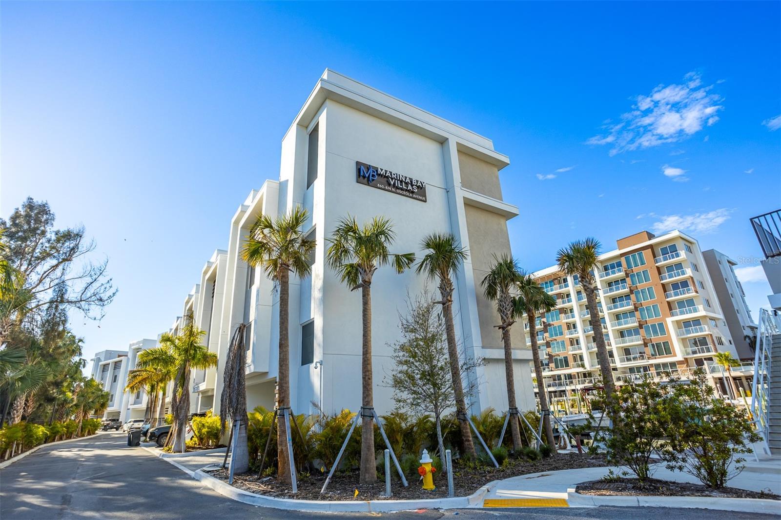 Look at this Price Improvement! Wake up to the rhythm of the marina and end each day with Clearwater sunsets from your own private rooftop retreat. This newly built, never lived in waterfront townhome is more than a residence. It is a lifestyle designed for those who value elegance, ease, and a front row seat to coastal living in Clearwater. Just minutes from downtown, the home welcomes you through a private gated entrance with direct access to your two car garage, setting the tone for a refined yet effortless day to day experience. Inside, natural light pours across luxury vinyl plank flooring, highlighting soaring tray ceilings with soft accent lighting and an architectural floating light oak staircase. A private elevator connects every level, making daily living and entertaining seamless. Expansive balconies on multiple floors invite you to step outside and take in sweeping marina views, morning coffee and evening tea. The kitchen is the heart of the home and it delivers. Designed for both elevated entertaining and everyday enjoyment, it features a five burner gas cooktop, built in microwave and oven, solid wood shaker cabinetry with pull out drawers, quartz countertops with a breakfast bar, and a dedicated wine fridge ready for hosting nights in or intimate dinners with friends. The primary suite is a true retreat. Begin and end your day on your private balcony, then unwind in your spa inspired bathroom complete with dual vanities, a frameless glass walk in shower, and generous his and hers walk in closets that balance luxury with functionality. At the top, the rooftop level transforms the home into an entertainer’s dream. A bonus room with a second kitchen opens through folding glass doors to an expansive patio with a wood deck. Fire up the built in outdoor gas grill, host unforgettable gatherings, or simply watch the sun dip below the horizon as the marina lights glow below. A large storage room on the entry level offers flexibility to create a home gym, private office, or additional storage, adapting effortlessly to your lifestyle. Perfectly positioned near downtown Dunedin and downtown Clearwater, you are moments from live music at BayCare Sound, iconic performances at The Capitol Theatre, and a vibrant mix of dining, shopping, and waterfront entertainment. With easy access to St. Petersburg and Tampa, both approximately 35 minutes away, convenience meets coastal sophistication. This is Clearwater living at its finest. Elevated, effortless, and undeniably luxurious. Important notes: The property is not furnished. Listing photos are from a professionally staged model unit. Minimum lease term is six months. Property is currently not staged. Water and trash are included. electric and gas are not included
