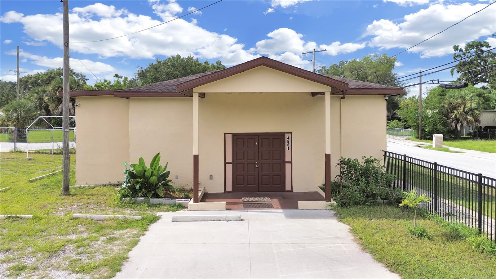 Introducing 4501 N 42nd St, Tampa, FL 33610 — a versatile, fully fenced assembly building perfect for your organization's next chapter. Built in 1951 and offering 1,720 square feet of interior space, this property sits on a generous 10,000 SqFt lot (0.23 acres), with capacity for 19 to 30 parking spaces — a rare find in this area. Inside, you'll find two restrooms, central A/C, and a layout that’s move-in ready and furnished with seating, making it ideal for religious services, community gatherings, or creative use. The exterior features a durable stucco finish and a shingle roof, while a sturdy metal gate provides added security. Utilities are easily accessible with public connections in place. Whether you're looking to expand an existing ministry, establish a new meeting space, or invest in a flexible-use property, this well-maintained assembly building offers incredible value and functionality in a convenient Tampa location. Contact us today to schedule your private tour.