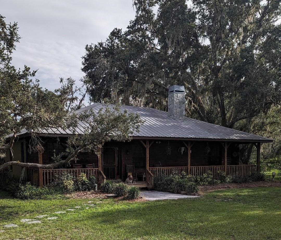 Beautiful 31 acres located on the Manatee River in Myakka. From the time you drive in you will be hooked. The beautiful 3 bed 2 bath block home with cedar siding resembles a peaceful cabin in the woods. The home is nestled between large oaks. Sitting inside near the fireplace or outside on the front porch, you can see the green open pastures with gentle cattle grazing. Sitting in the dining room or out on the rear porch next to the pool, you can watch the wildlife rustling about. Sometimes it's squirrels and other times it might be deer and turkeys. Put in a canoe or jon boat to fish the river or explore your 2+ acres on the south side.  Along the southwest side (in the woods) there is a small historical cemetery (Stewart Family Cemetery) that can only be visited by appointment with the homeowner.