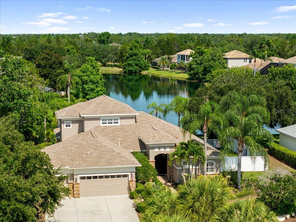 This one of a kind POOL home is perfectly positioned on an oversized CUL-DE-SAC lot in the highly sought-after Greenbrook Village of Lakewood Ranch. Offering 3,142 square feet, 4 bedrooms, 4 bathrooms, bonus room, A/C controlled workout space, huge fenced in side yard, and stunning long lake views, this home combines privacy, convenience, and the Florida lifestyle buyers are searching for all wrapped up in your home.

Inside, you’ll find bright, open living spaces and thoughtful updates throughout. The updated kitchen (2022) serves as the heart of the home and features quartz countertops, a dramatic waterfall peninsula, a full-height quartz slab backsplash, updated appliances, and modern finishes. Recently painted on the interior, new carpeting upstairs, CUSTOM CLOSET systems, and blackout remote-controlled blinds add both style and functionality throughout the home.

Designed for everyday living and entertaining, the outdoor space is truly special. The recently RESURFACED pool and upgraded pool deck with a full pool bath create a resort-style setting overlooking the tranquil lake, while the fenced side yard features putt putt, perfect for outdoor fun. Additional upgrades include refreshed landscaping, new exterior lighting, a retractable patio sunshade, updated SONOS SURROUND SOUND inside and out, an epoxy-coated garage floor, and a climate-controlled WORKOUT SPACE.

Major improvements include an UPDATED ROOF in 2021 which was also recently sealed and both HVAC systems were replaced in 2021.

What truly sets this property apart is its location. Greenbrook Trails is one of Lakewood Ranch’s most beloved neighborhoods, known for its mature landscaping, larger homesites, and lovely atmosphere. Nature trails are located just outside your front door and connect directly to Greenbrook Adventure Park, featuring playgrounds, sports fields, basketball courts, pavilions, and open green space. Top-rated schools are just minutes away. You’ll also enjoy quick access to Lakewood Ranch Main Street, Waterside Place, dining, shopping, events, and everything that makes Lakewood Ranch one of the nation’s premier master-planned communities.