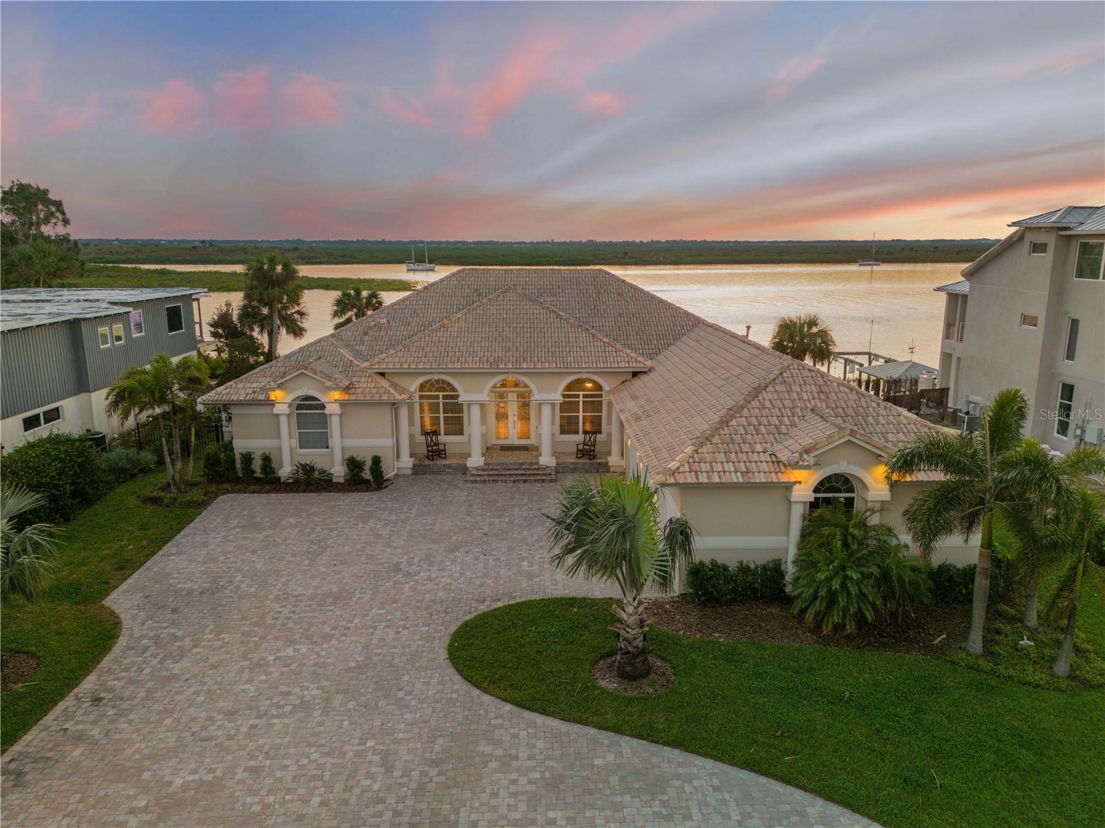 The best location in New Smyrna Beach for lifestyle, boating and beaching. Sitting on 108' of intracoastal waterway on north beach, and one of the closest homes to New Smyrna Beach Inlet without having to pass under a bridge on your way offshore if you own a large boat. Lounge in your backyard with your newly built custom pool/spa and gas fire pit for amazing daily sunsets. Also, perfect walkability to the shops and restaurants of downtown New Smyrna Beach's Flagler Ave or walk down to Smyrna Dunes Park, dog beach or the Inlet. Drive your golf cart to Publix for a few last minute items or anywhere in town from this location as well. This home has an open layout with 4 bedrooms and 3 full bathrooms having breath taking views from the living room, kitchen and primary bedroom. Huge 3 car garage and approx. 900 sqft of finished attic storage space above the garage and whole house generator with natural gas. Giant walk in closet and bathroom in the primary bedroom and a single story home so no stairs. Deep water dock with a Deco custom boat lift and jet ski lift. This home has everything and you have to see the views in person.